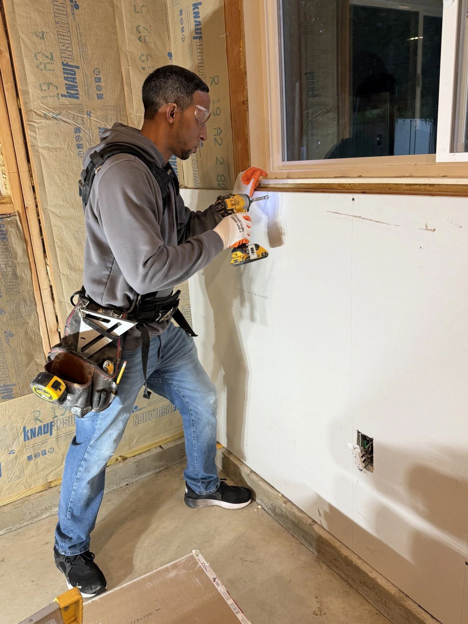 Rigoberto Martinez hanging drywall on a home renovation in Morris County, NJ