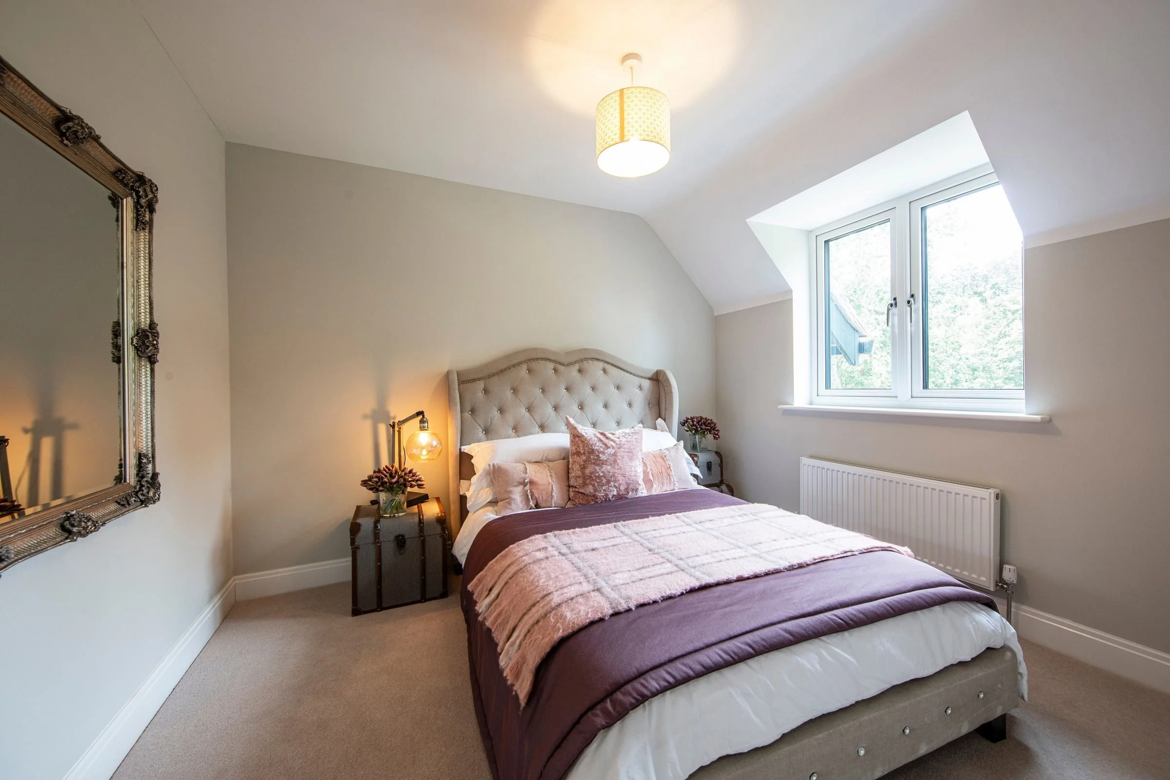 Bedroom 3 with a wide window and fitted carpet.