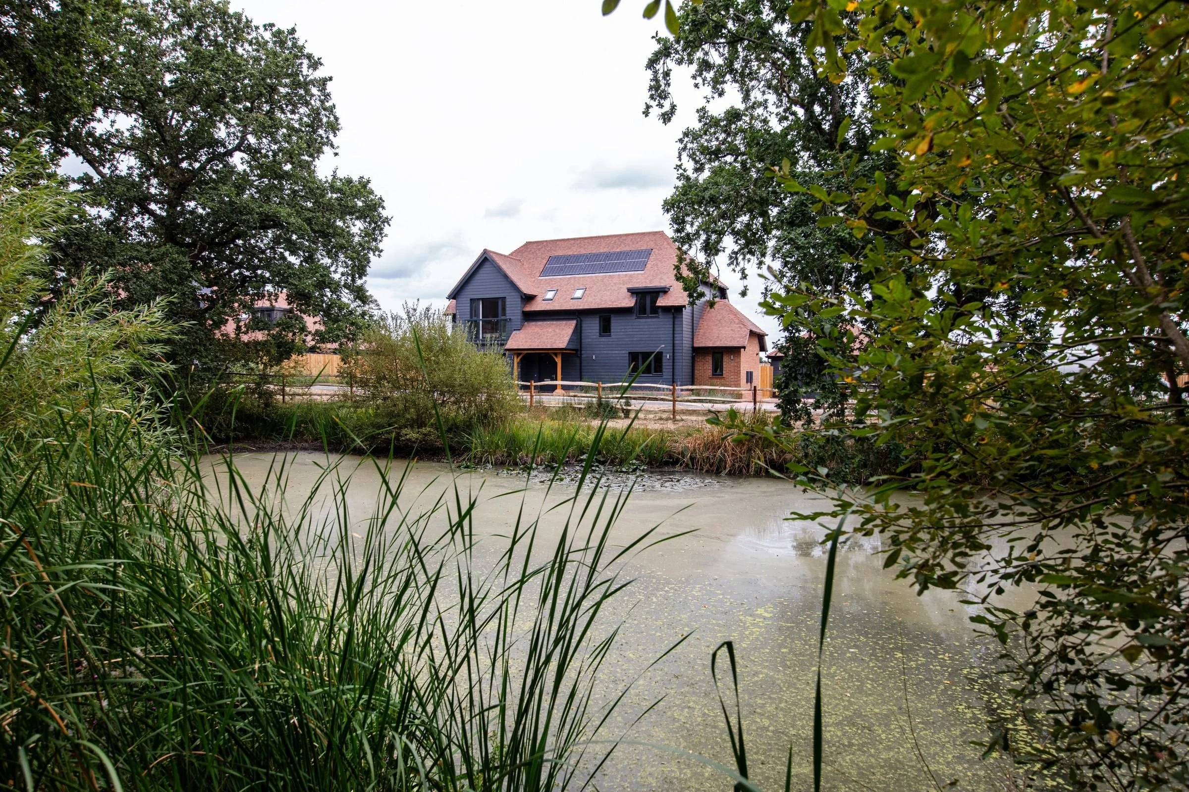 View of 4 Birdcage Lane across the pond at Goddards Green.