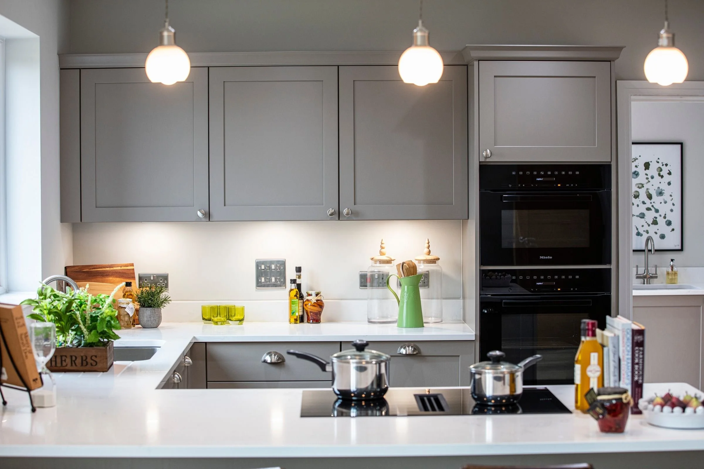 Induction hob and painted kitchen cabinetry.