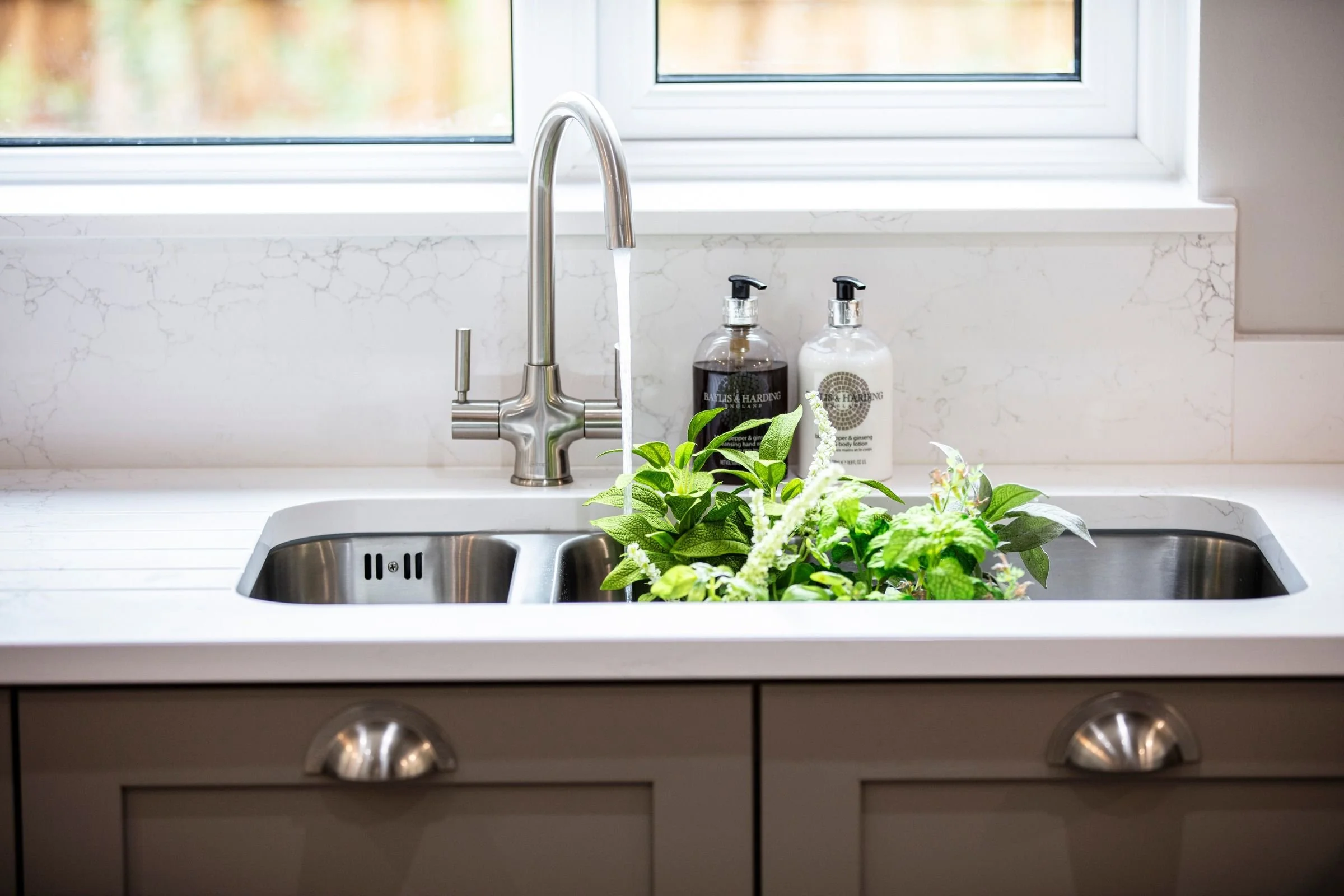 Stainless-steel undermounted sink and brushed nickel mixer tap.