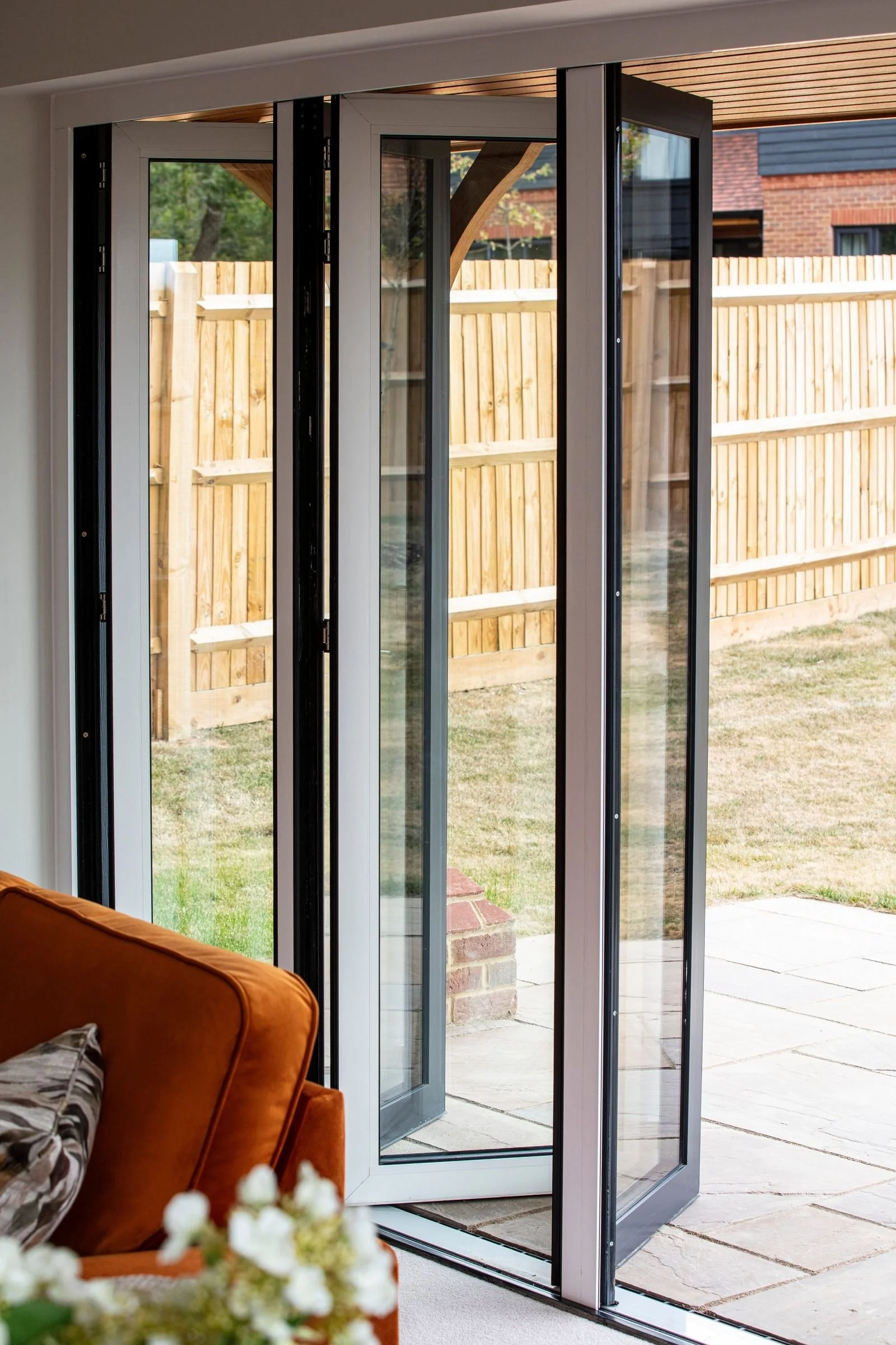 Open bifold doors connecting the lounge with the patio and garden.