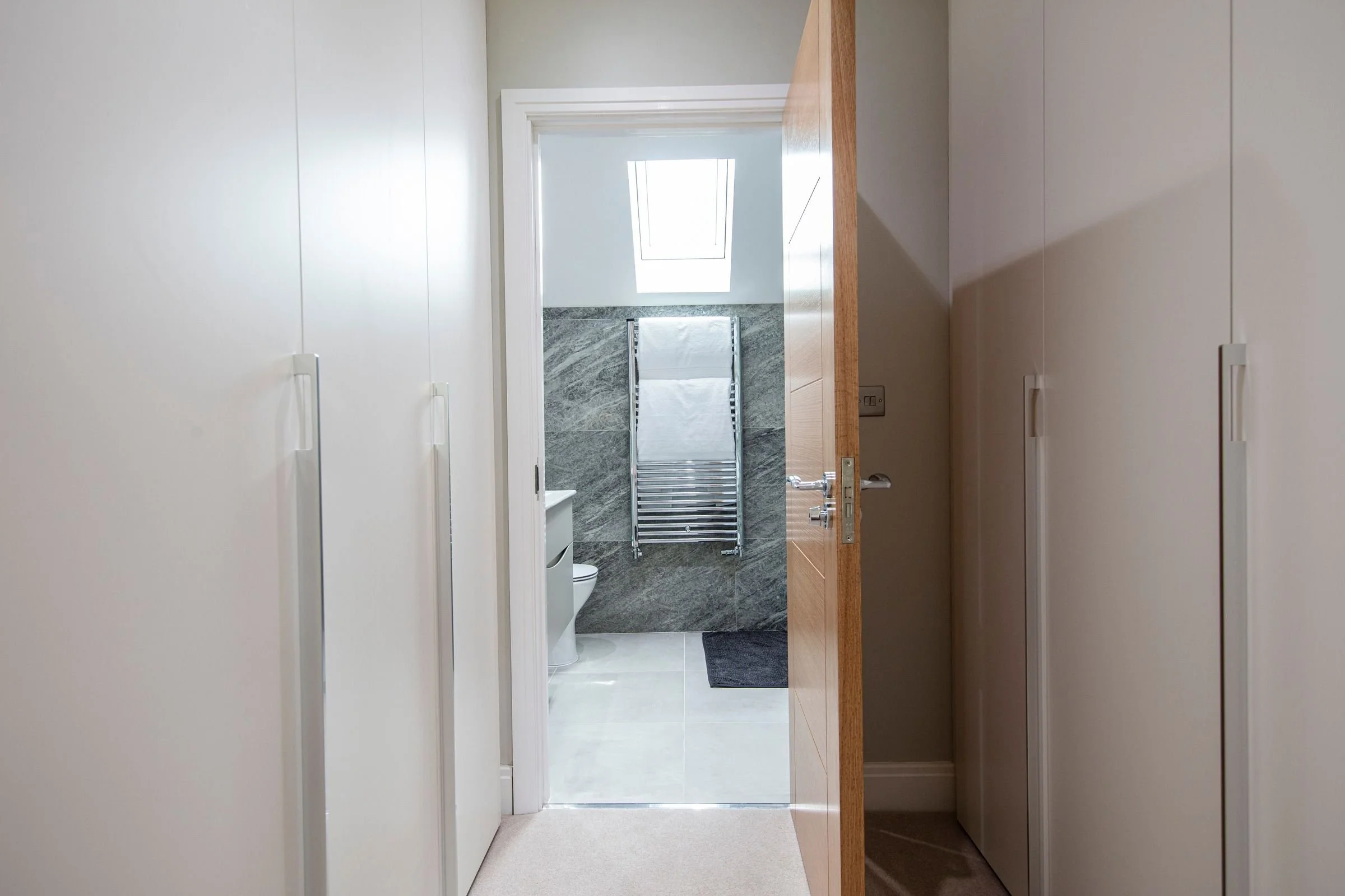 Fitted dressing area leading into the primary ensuite.