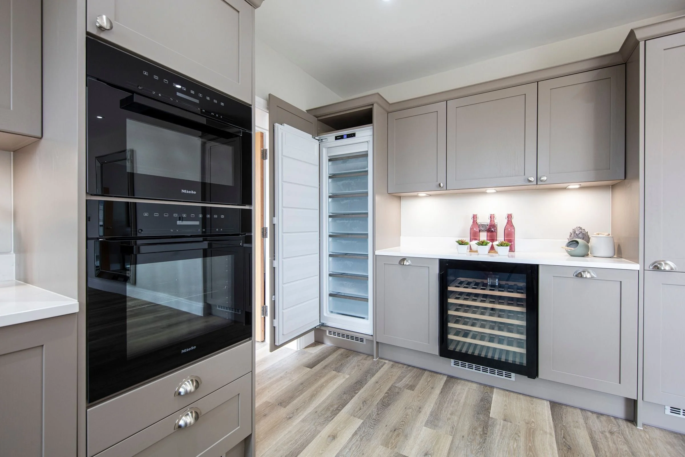 Integrated kitchen appliances and built-under wine cooler.