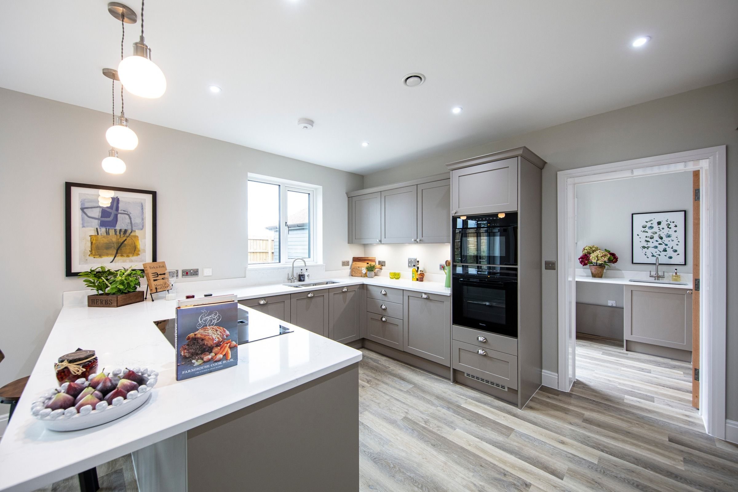 Painted Shaker kitchen with quartz worktops and peninsula.