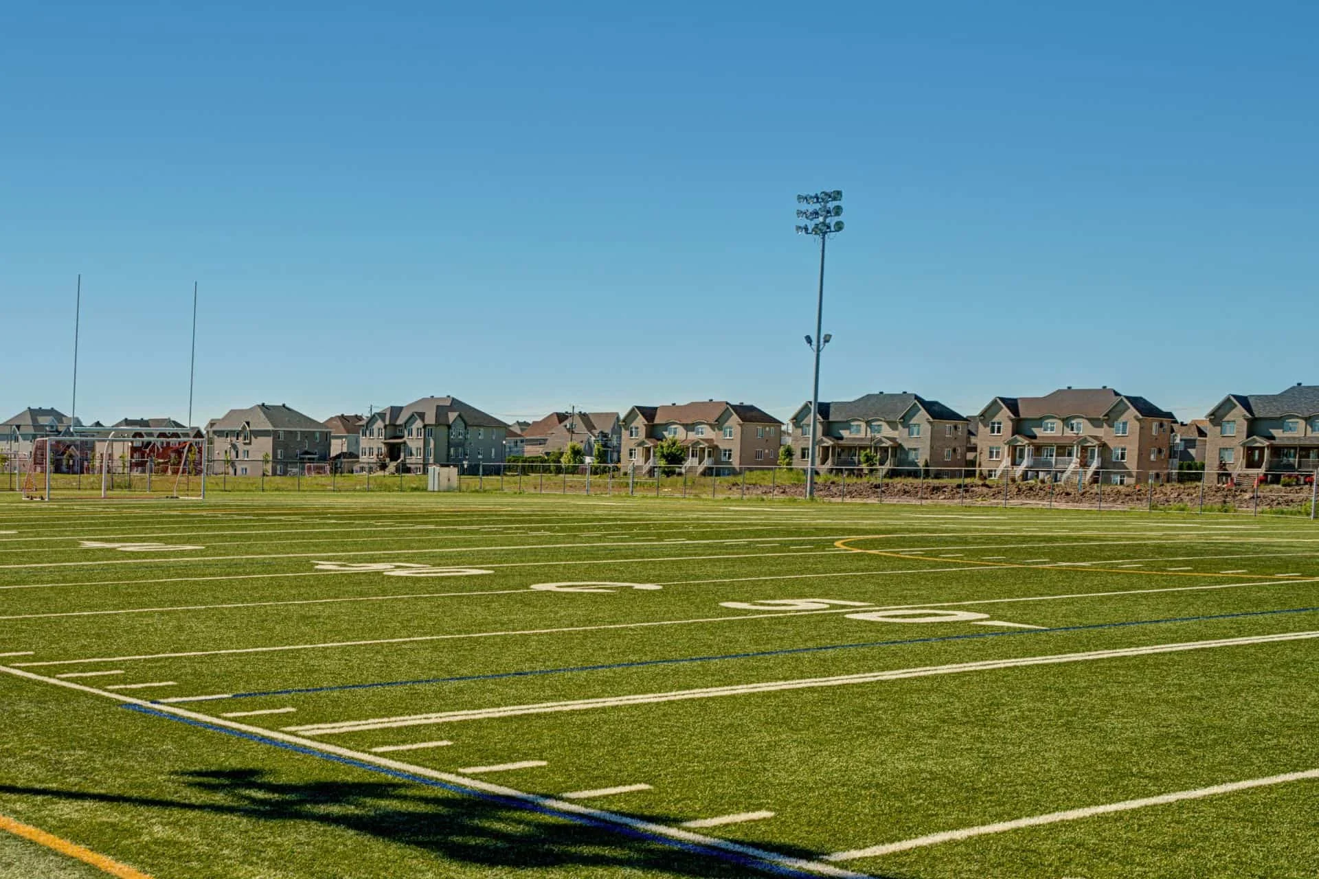 Marked football field with stadium lighting at an athletic complex in Wilmington, NC