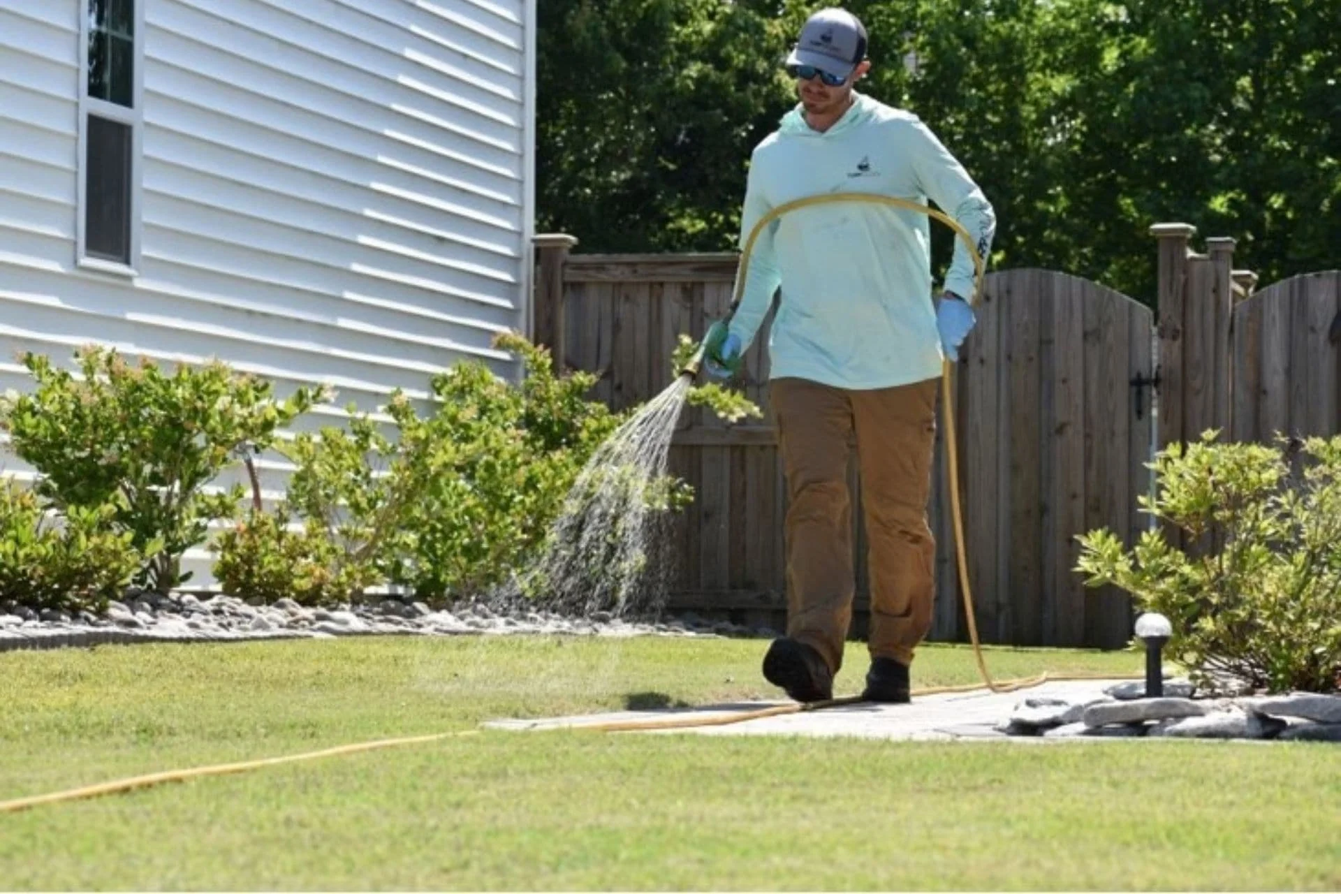 Turfology technician applying lawn treatment to a residential yard in Wilmington, NC