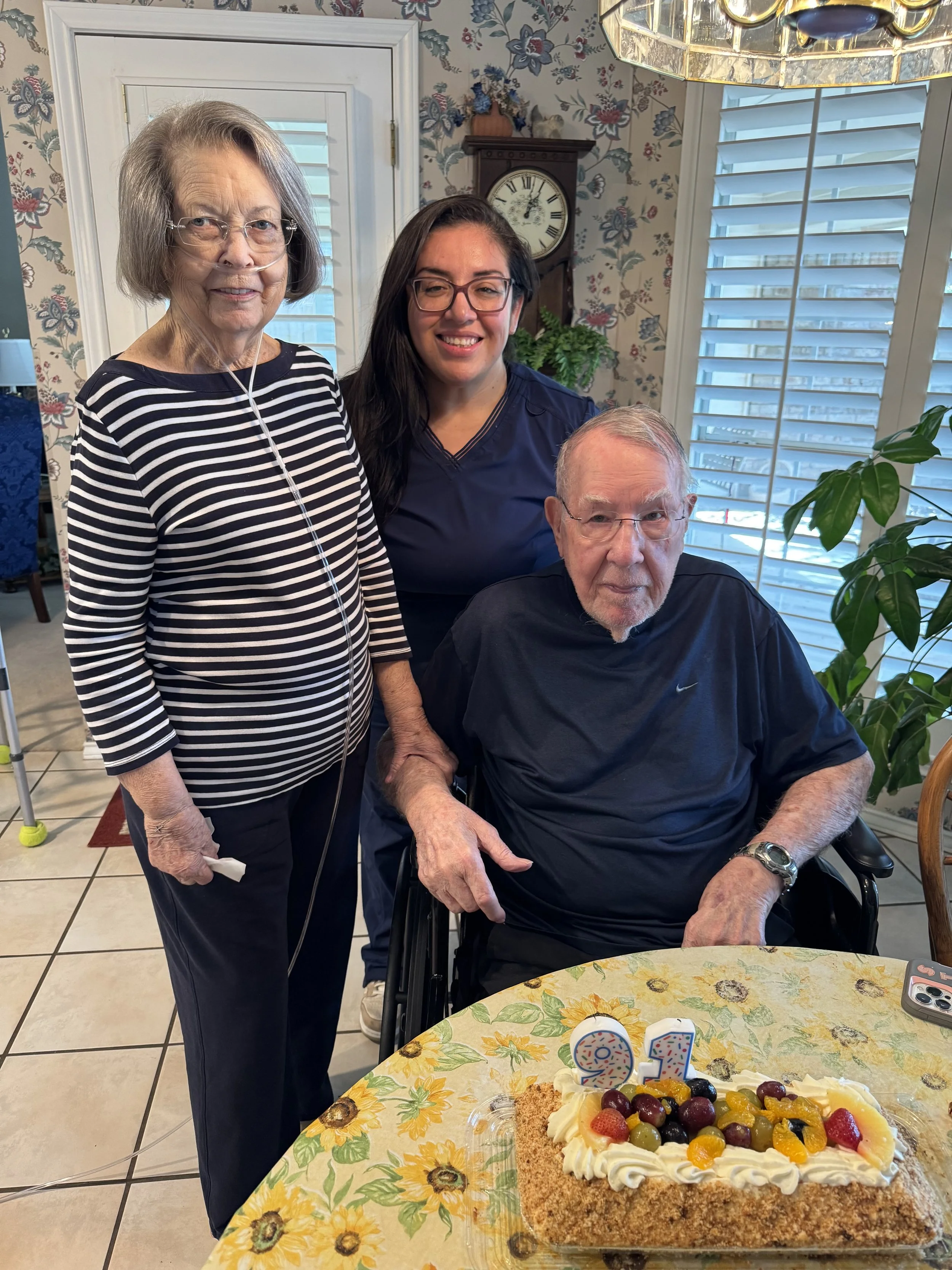 A caregiver celebrating a client’s 91st birthday with his family.