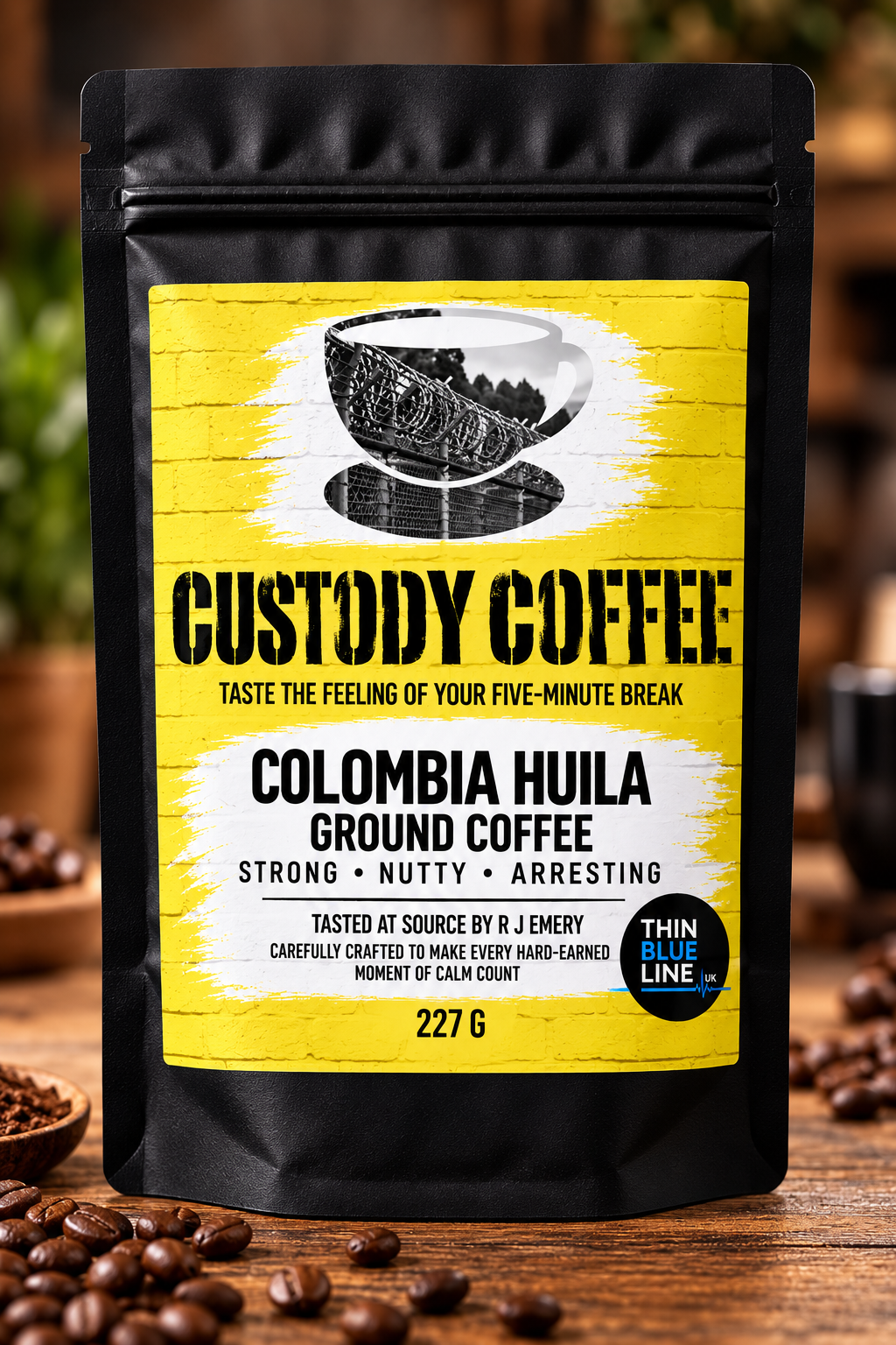 Black bag of Colombia Huila ground coffee with yellow and white label, a black and white illustration of a coffee cup, surrounded by coffee beans on a wooden surface.