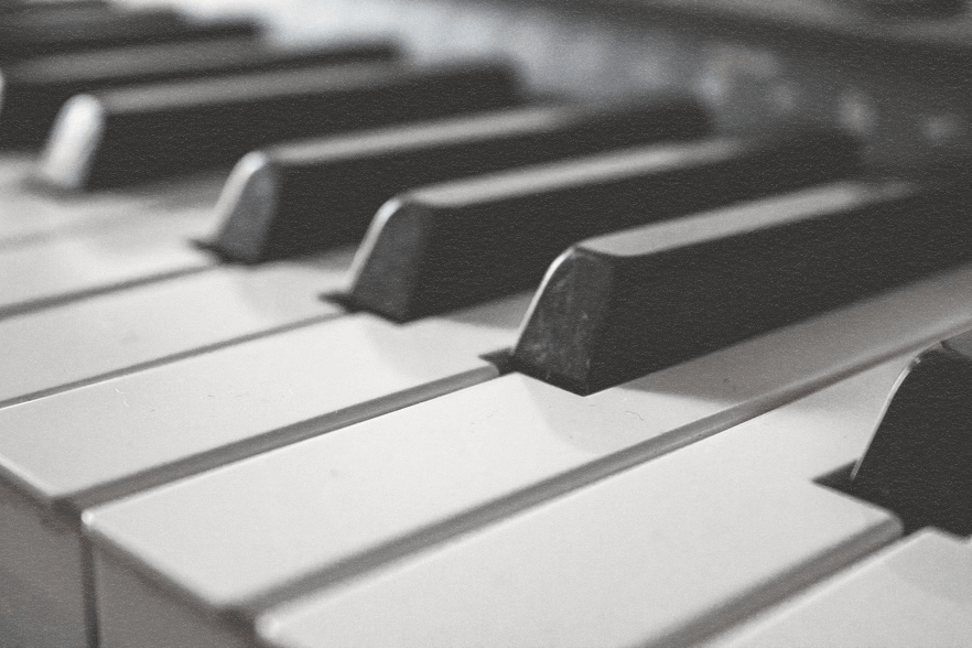 Close-up of a piano keyboard, showing black and white keys.