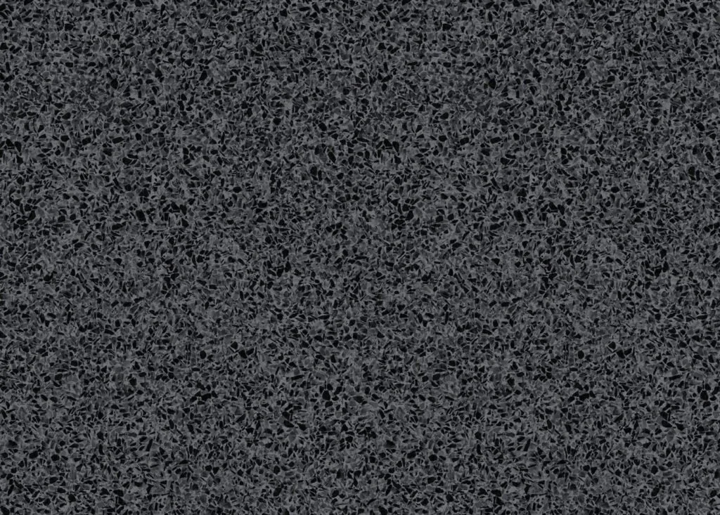 Surface en pierre ou en granite avec une texture granuleuse et un motif noir et gris.