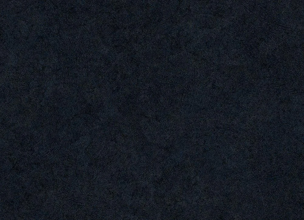 Surface sombre et granuleuse, probablement une pierre ou un matériau texturé noir.