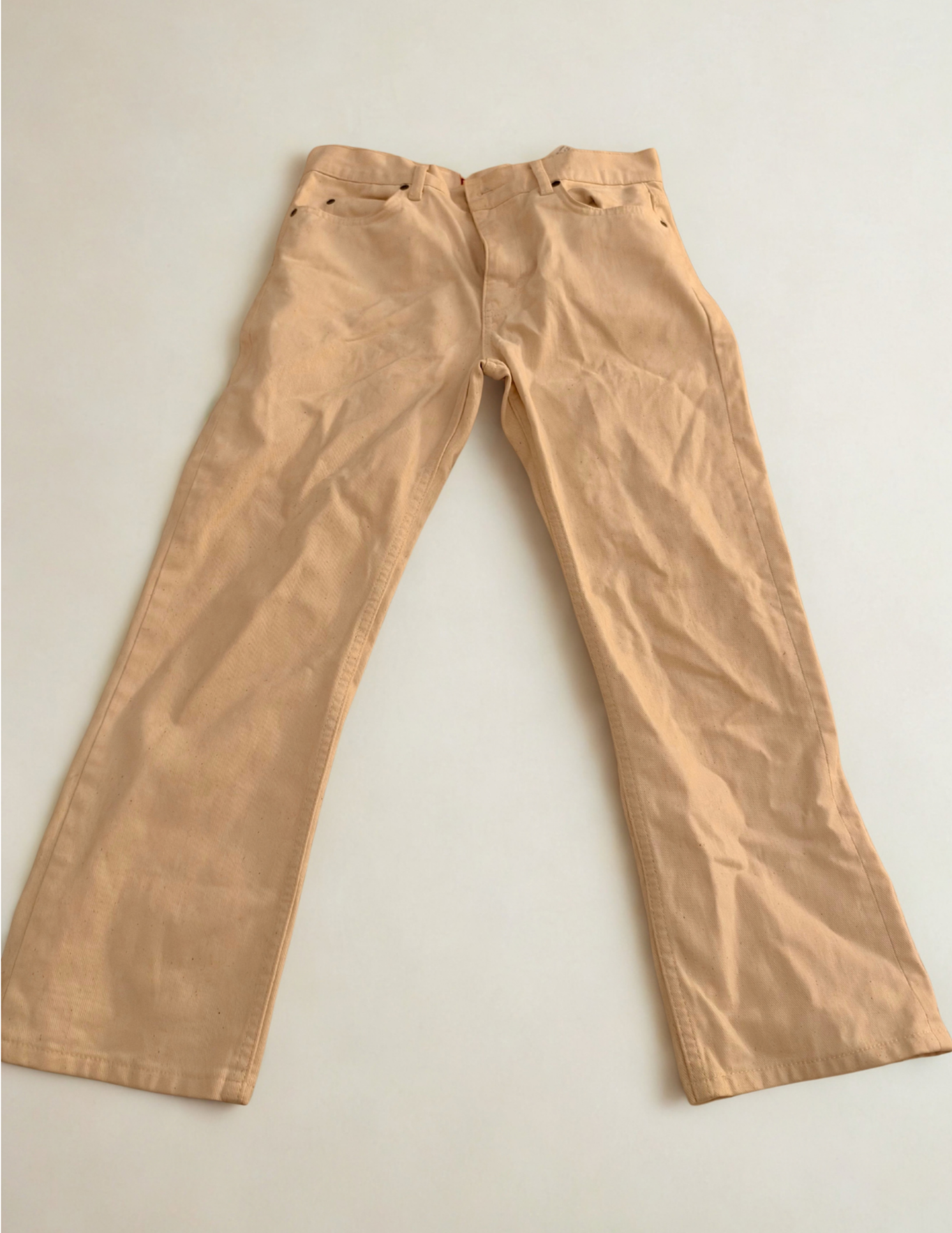 Cream colored boot cut ankle length jeans