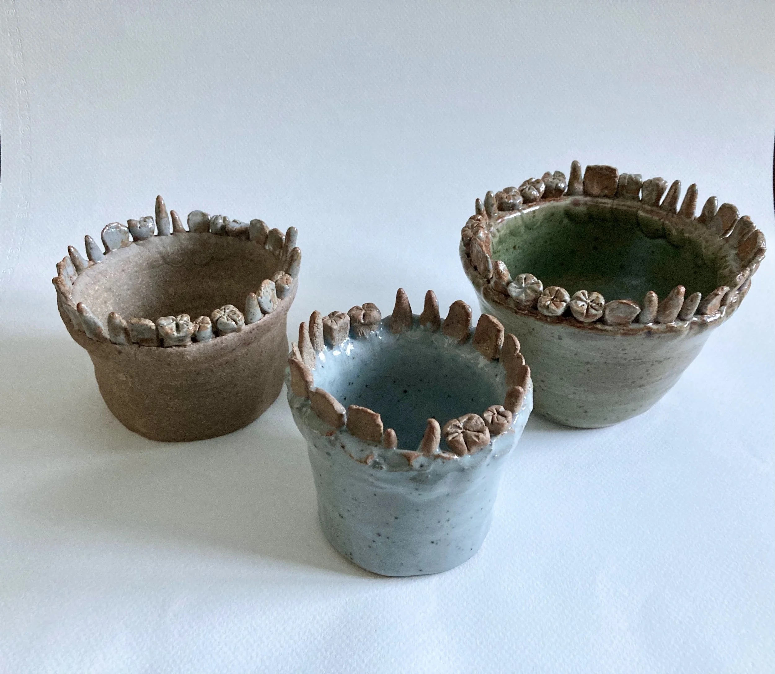 Stoneware vases with stoneware teeth accents