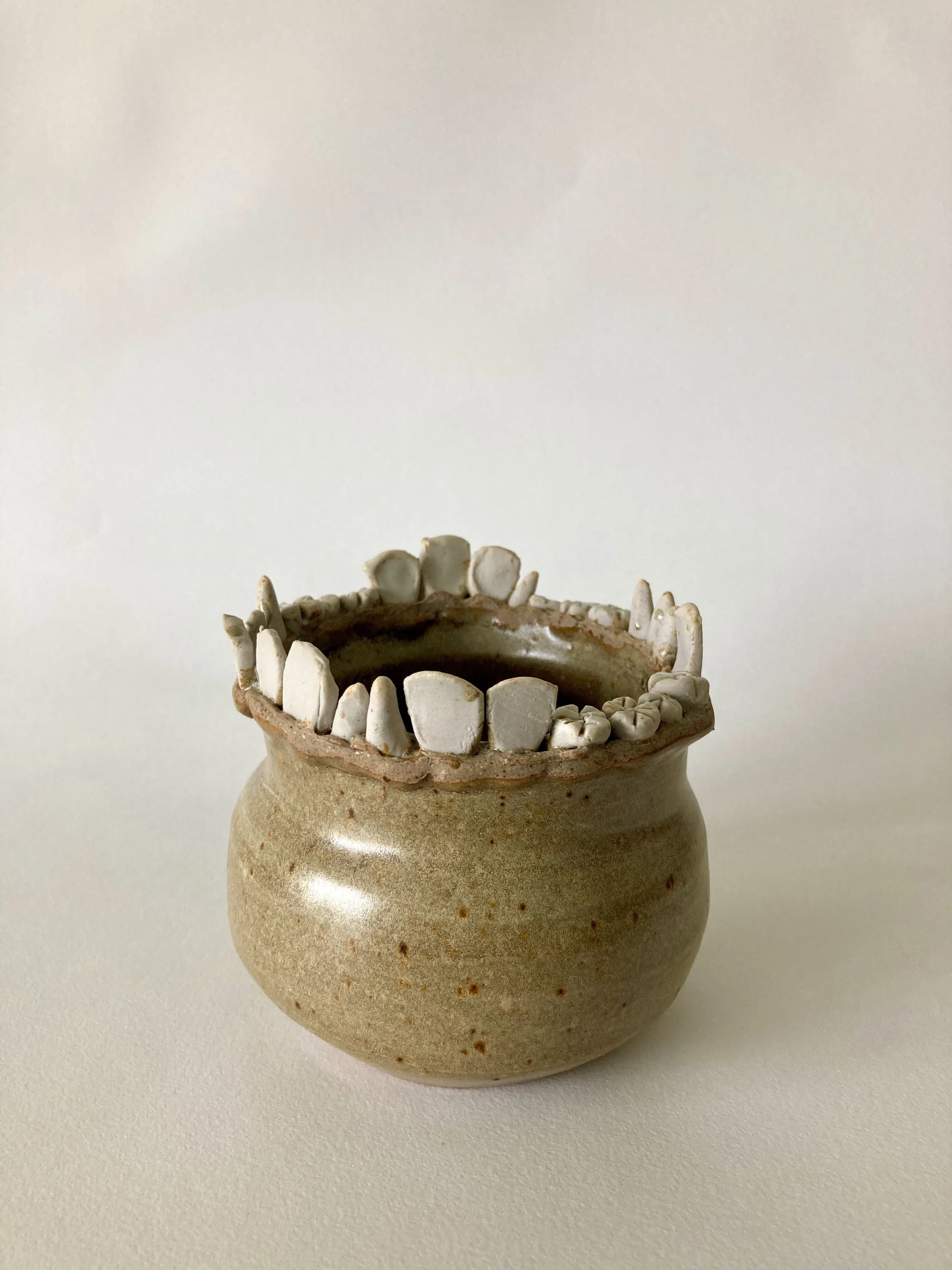 Stoneware vase with stoneware and porcelain teeth accents