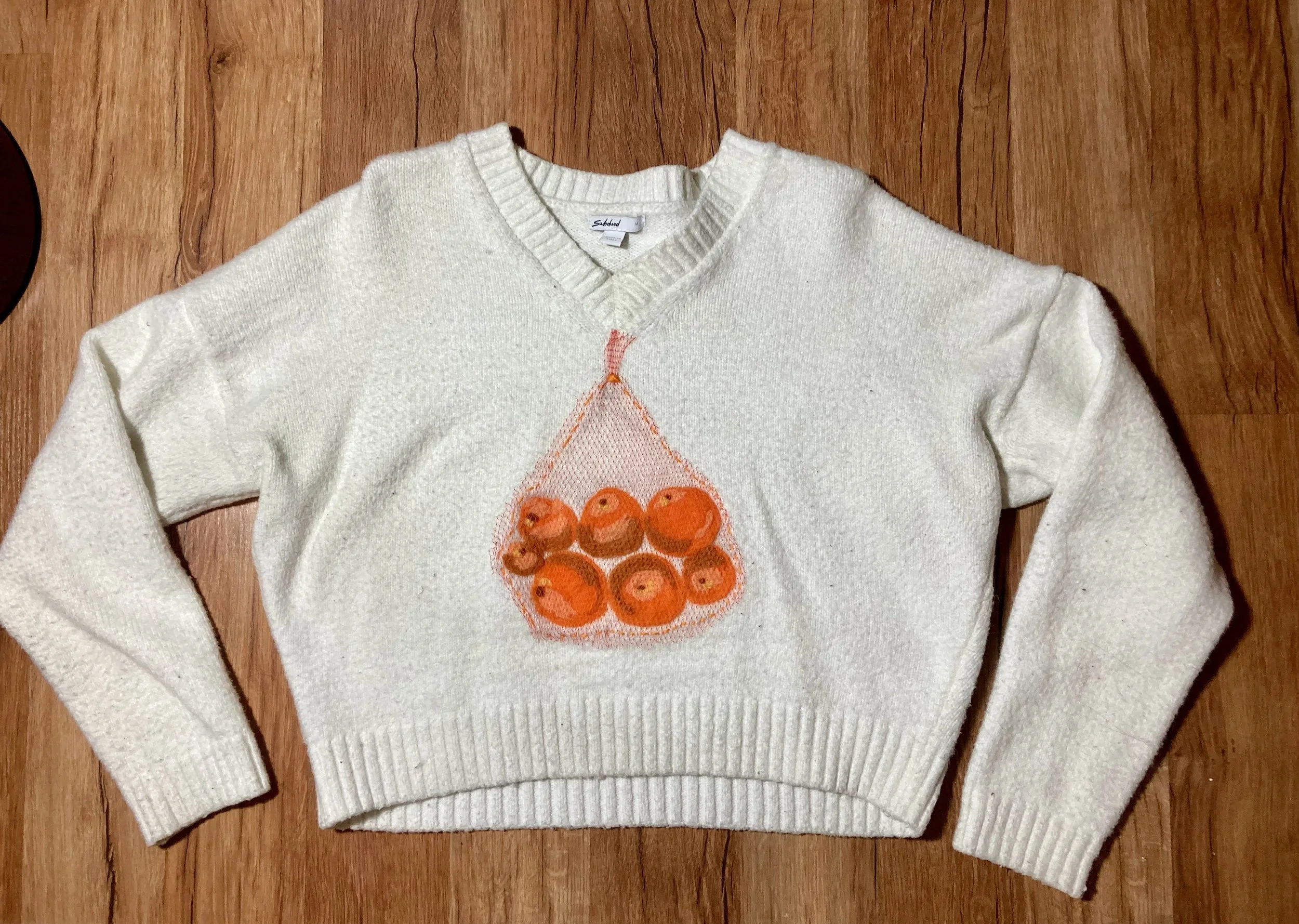 Upcycled sweater with needle felted oranges