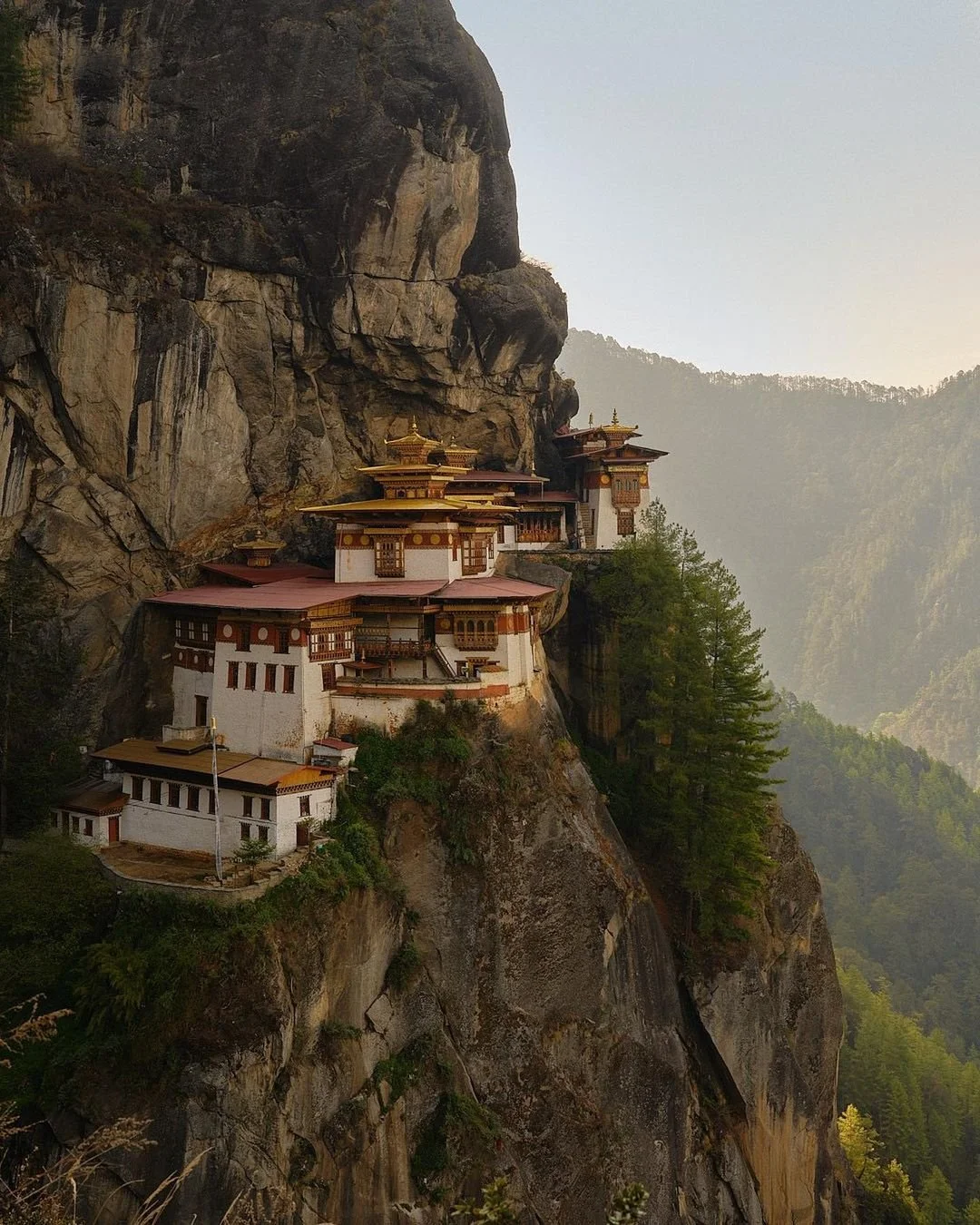 Bumi showcase a stunning view of Paro Bhutan, featuring the iconic Paro Taktsang (Tiger's Nest Monastery) nestled against the dramatic mountain landscape.