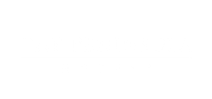 Sign displaying the name 'The Peninsula Motels' in white text on a black background.