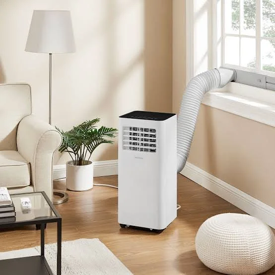 Portable air conditioner with flexible exhaust hose in living room