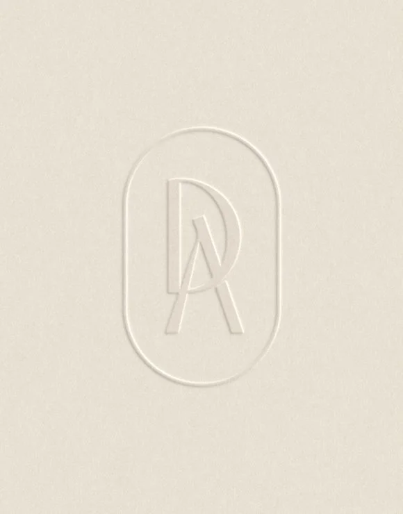 Embossed monogram logo design on printed stationery