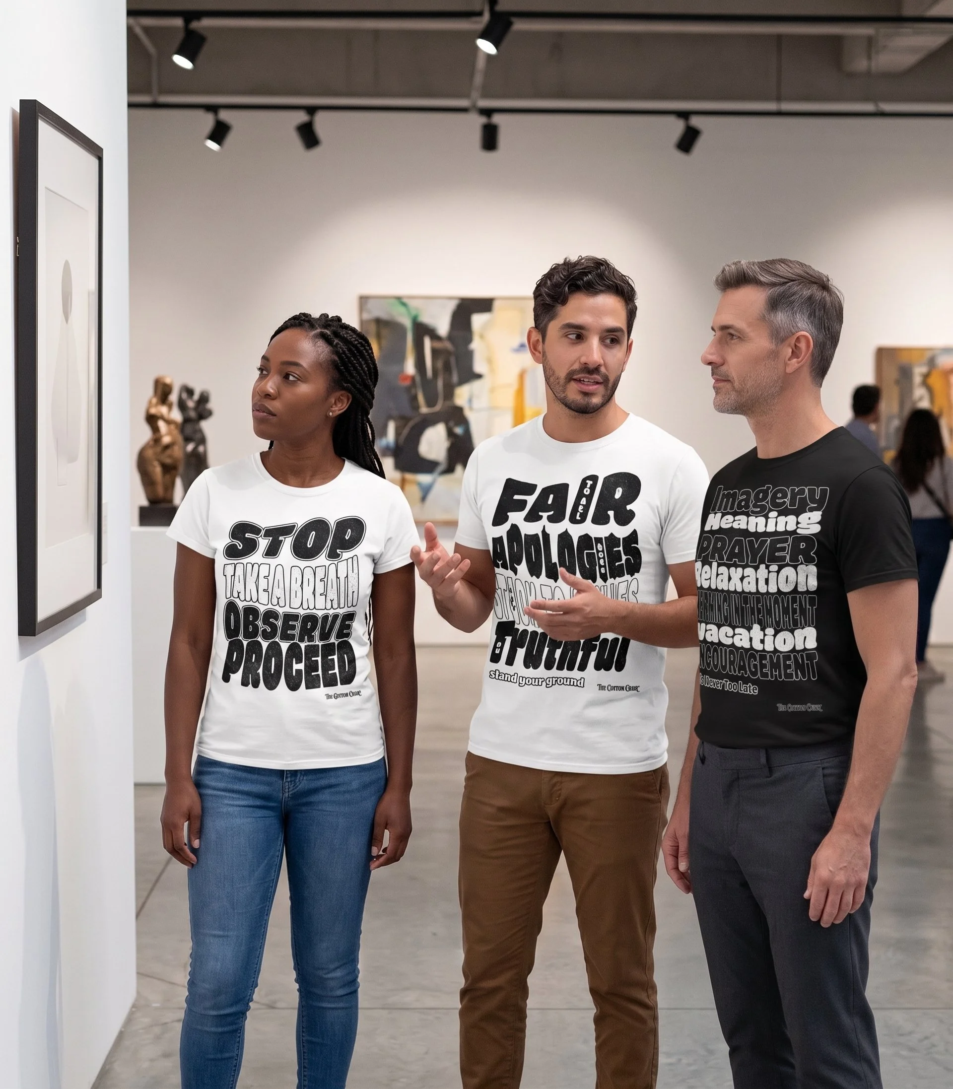 Three people talking in an art gallery. Two are wearing a unisex white cotton t-shirt with DBT original graphics on them and one person has a black t-shirt, also with DBT original graphics on them from The Cotton Crier.