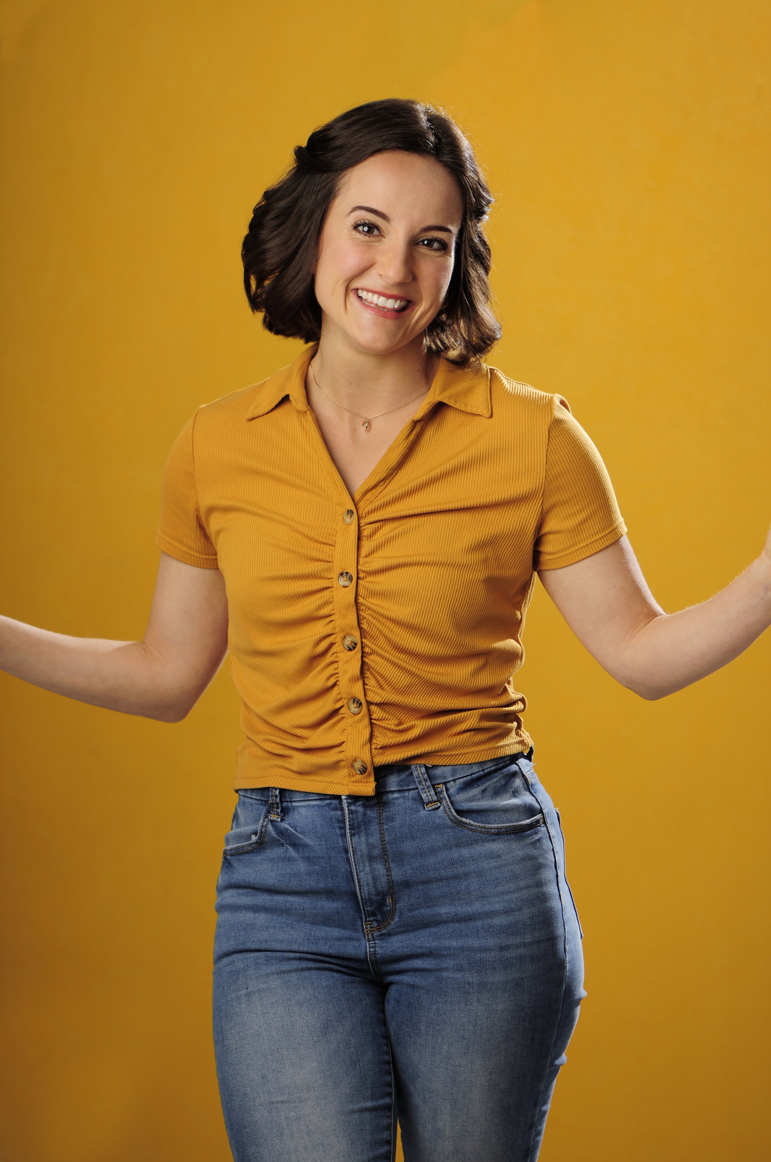Woman smiling with a yellow background