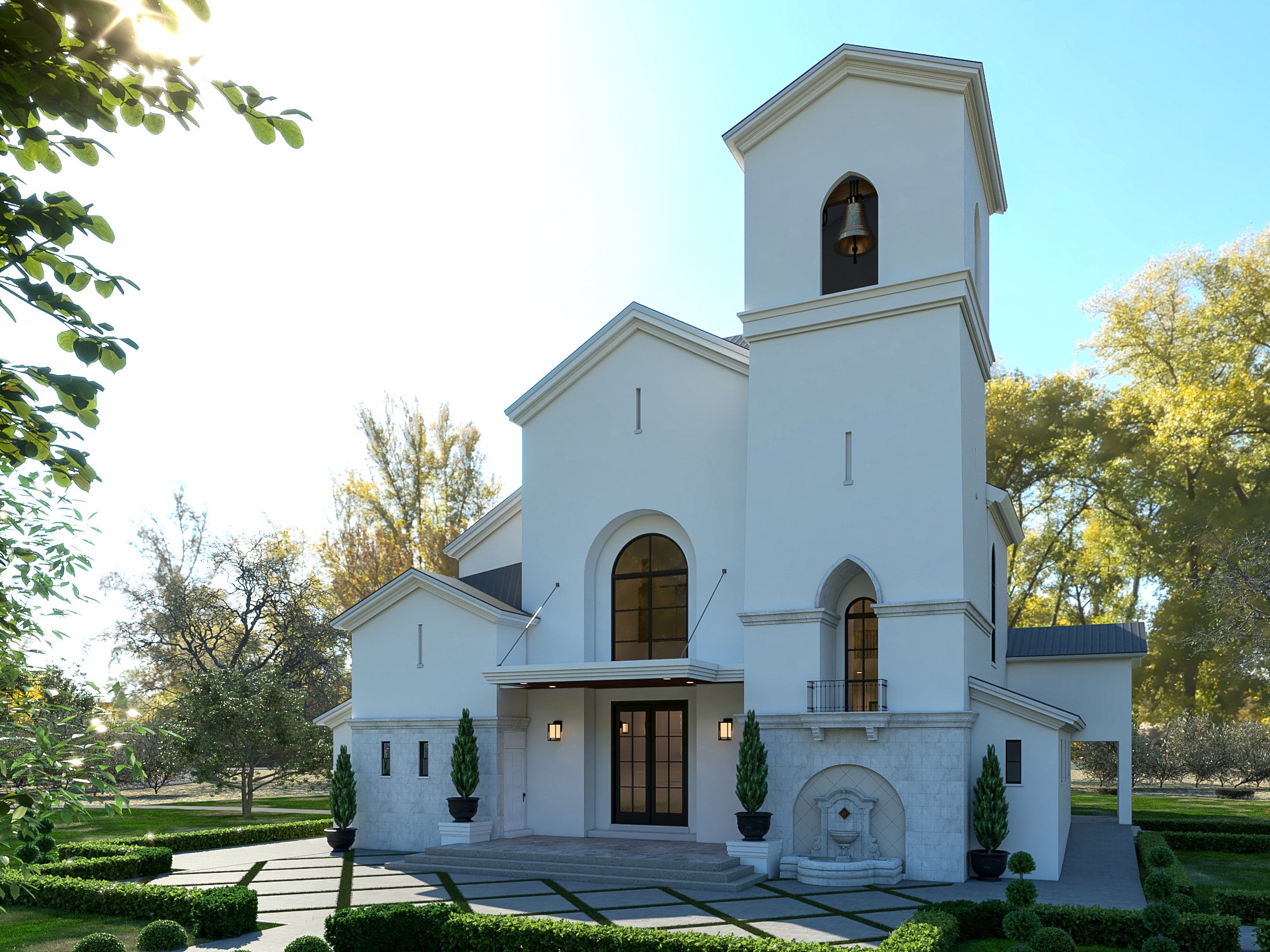 A white church with a bell tower surrounded by trees and a well-manicured lawn, with sunlight shining through the leaves.
