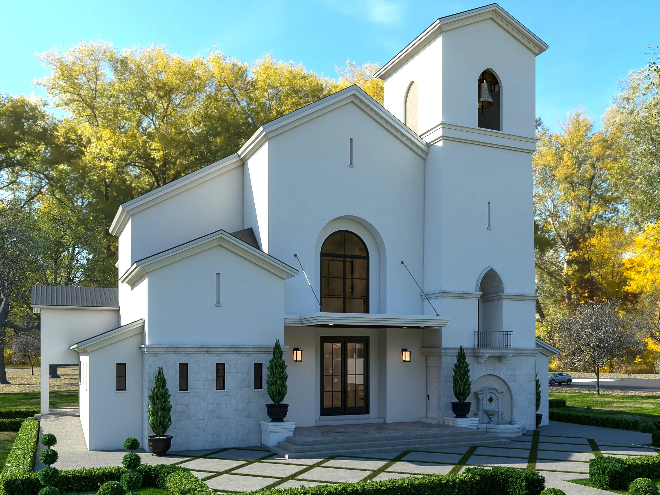 A white church with a bell tower and arched windows, surrounded by trees with yellow leaves, a manicured lawn, and potted plants at the entrance, under a clear blue sky.