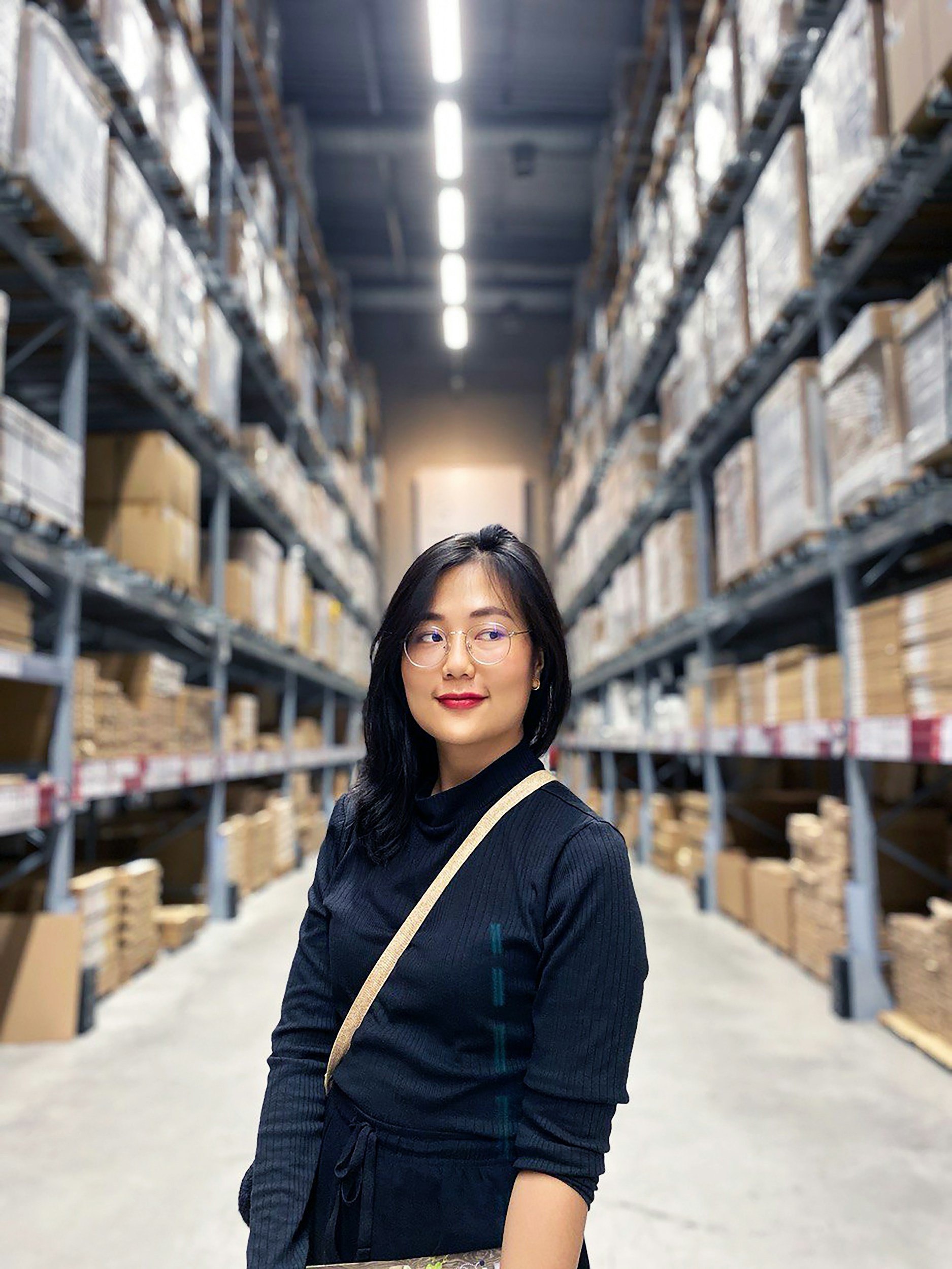 Warehouse worker in a distribution center aisle