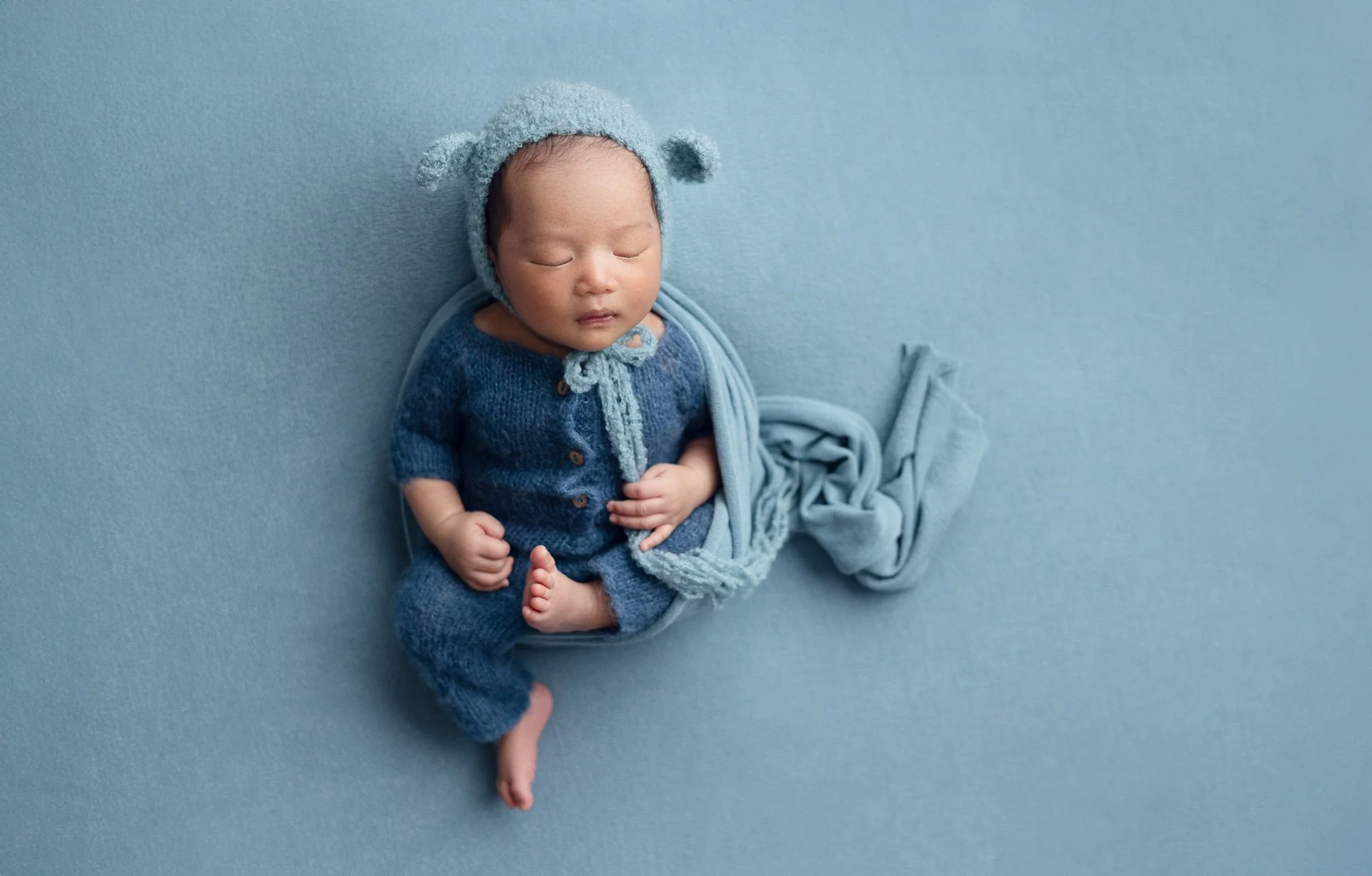 Sophie Lecavalier Photography newborn baby boy in teal colours with lamb ear bonnet.