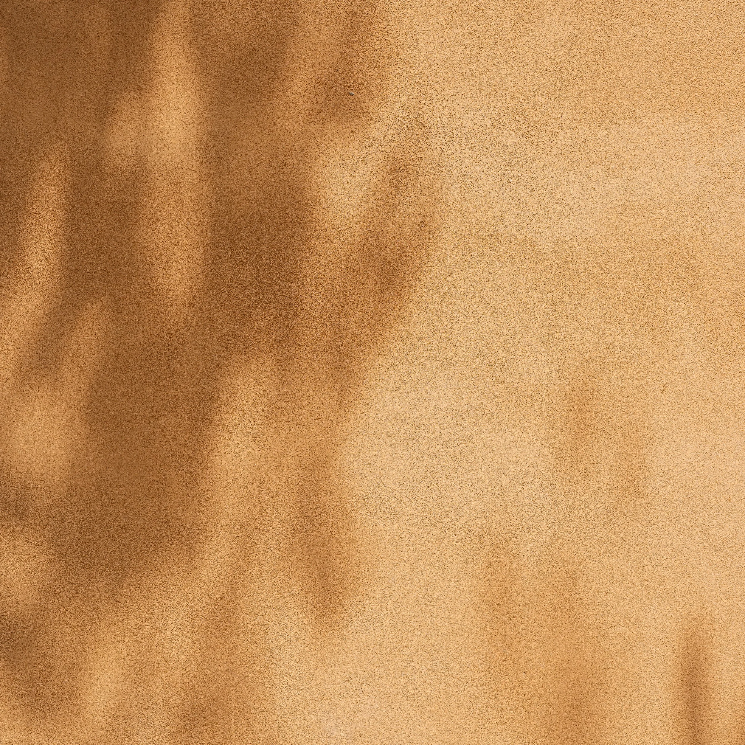 Close-up of a beige textured surface, possibly a wall or fabric