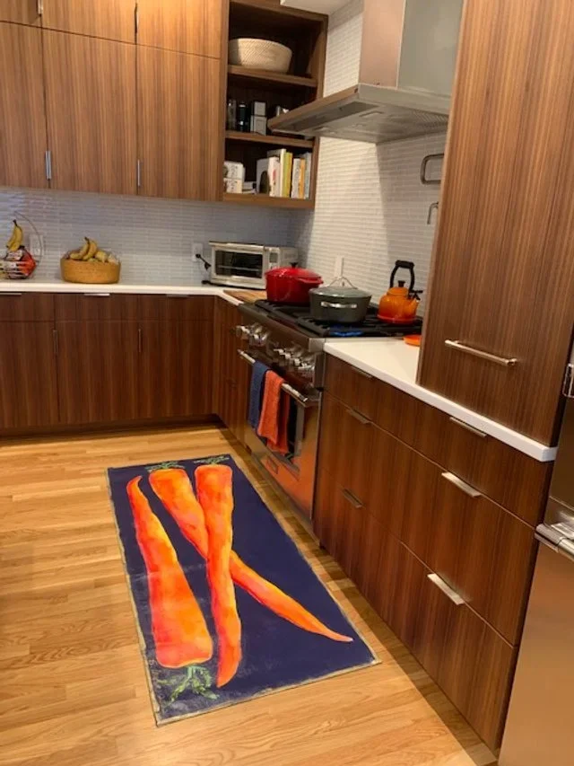 Kitchen with hand-painted canvas runner of carrots on black background