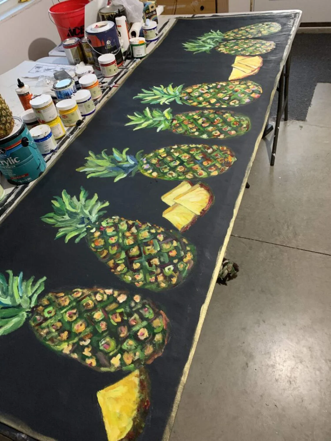 Hand-painted custom canvas runner of pineapples on black background, in studio, ready to ship!