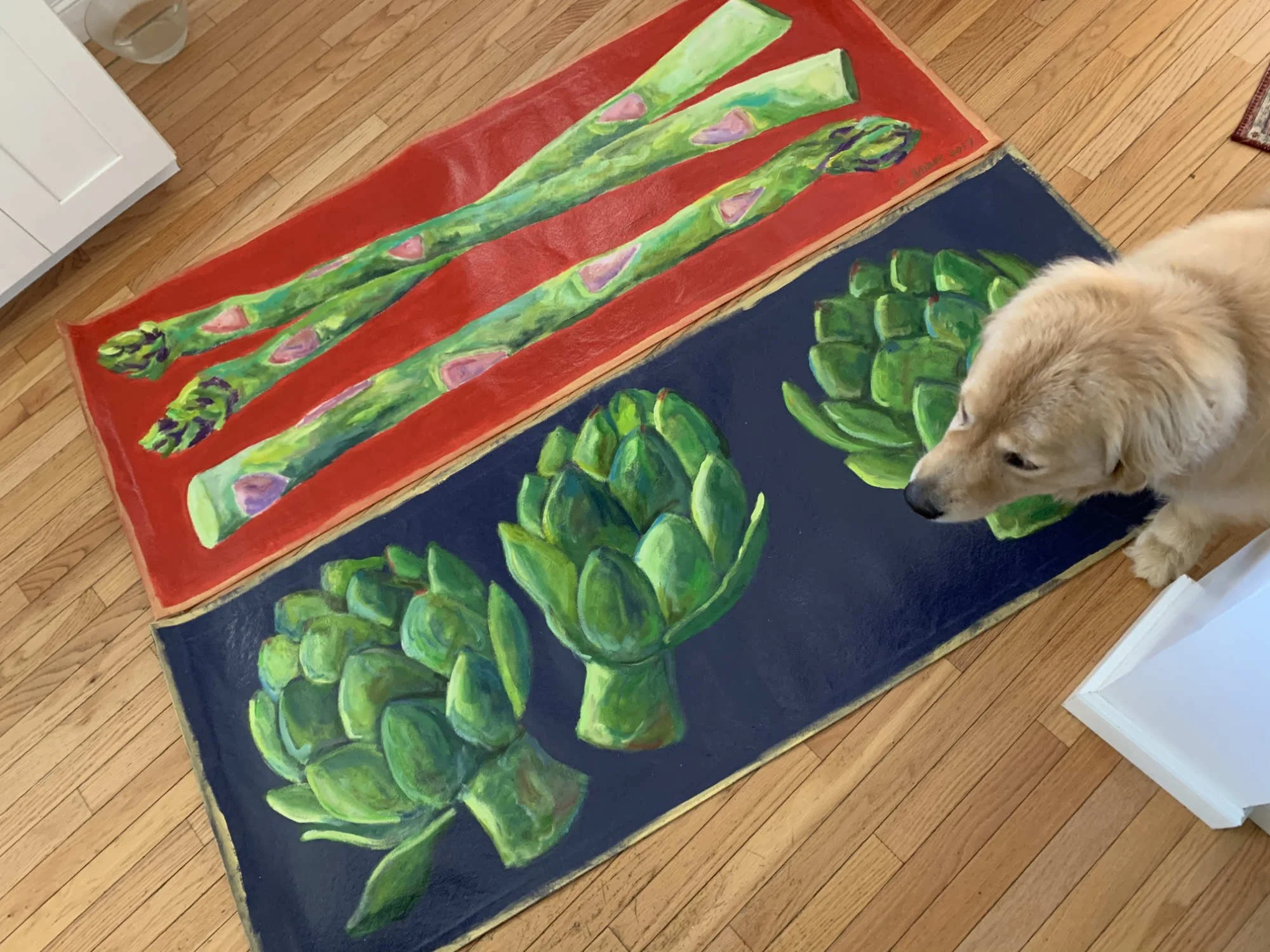 Two hand-painted canvas runners, one of artichokes on black background, and one of asparagus on red background