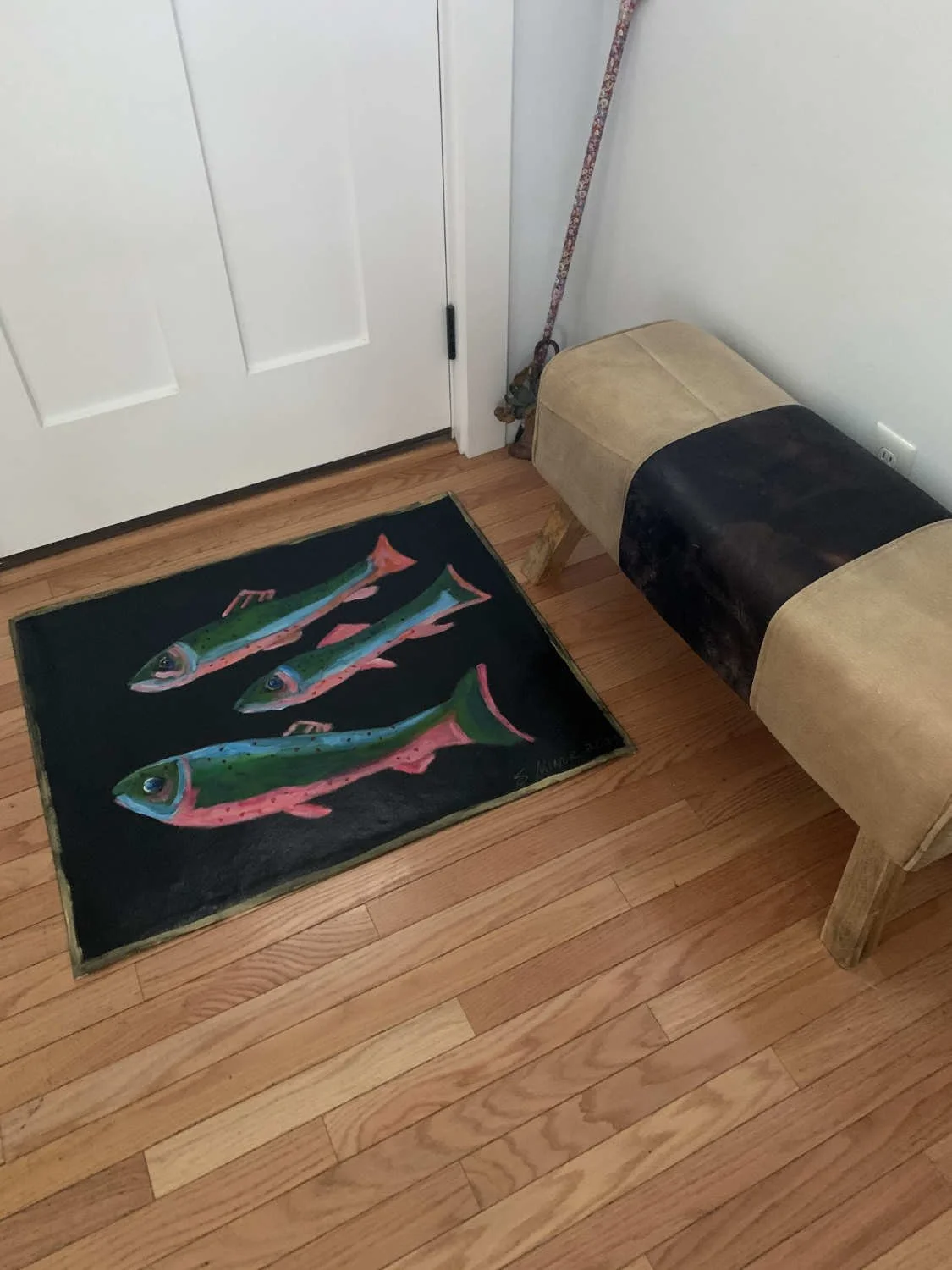 Door area with hand-painted canvas floorcloth of trout on black background