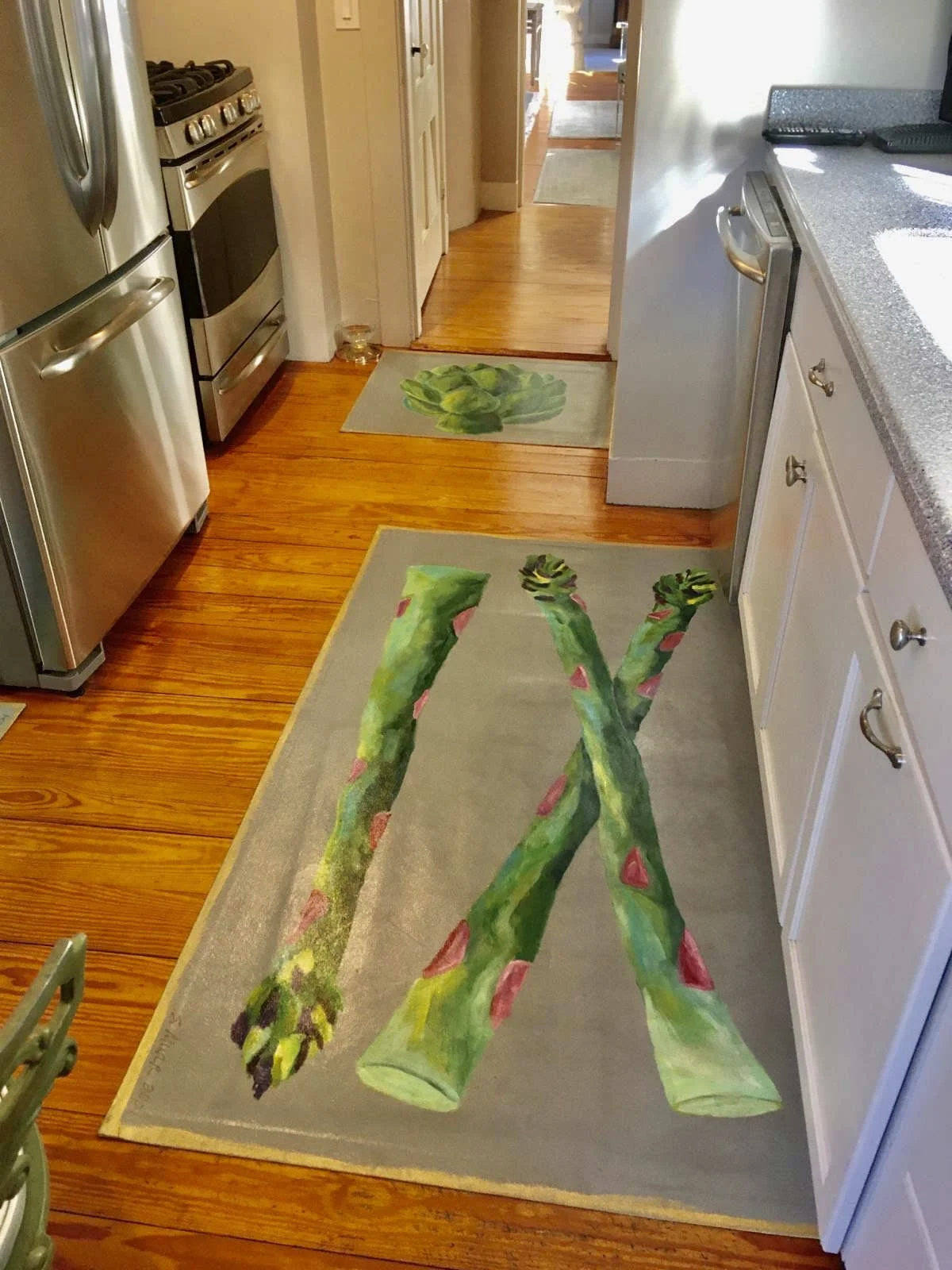Kitchen with hand-painted canvas runner of asparagus on gray background and floorcloth of artichoke on gray background