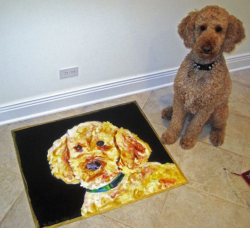 Hand-painted canvas floor cloth of golden-doodle on black background (with original subject beside)
