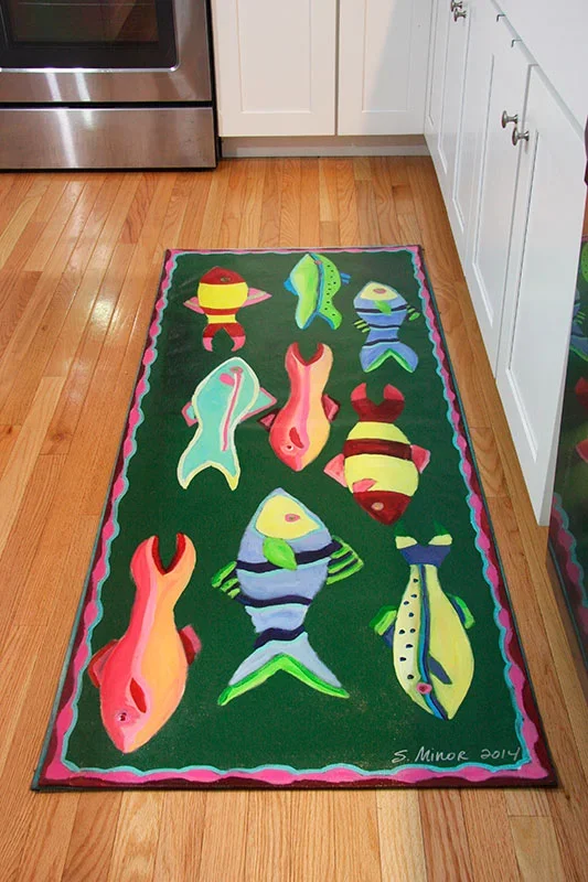 kitchen with hand-painted canvas runner of abstract fish school on green background