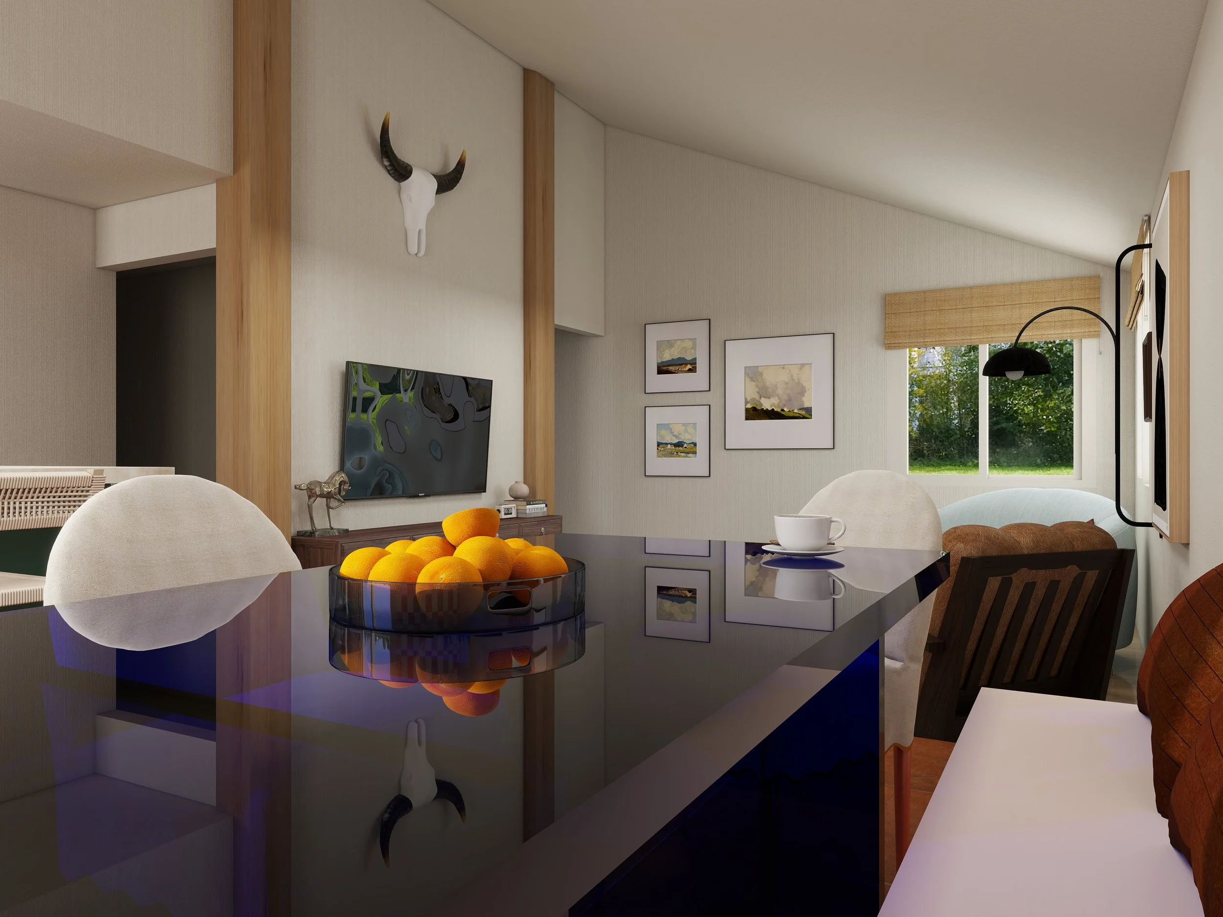 Living room with beige walls, wooden beam accents, wall-mounted bull skull with black and brown horns, framed artwork, window with view of greenery, black floor lamp, and dining table with a bowl of oranges and a white mug.