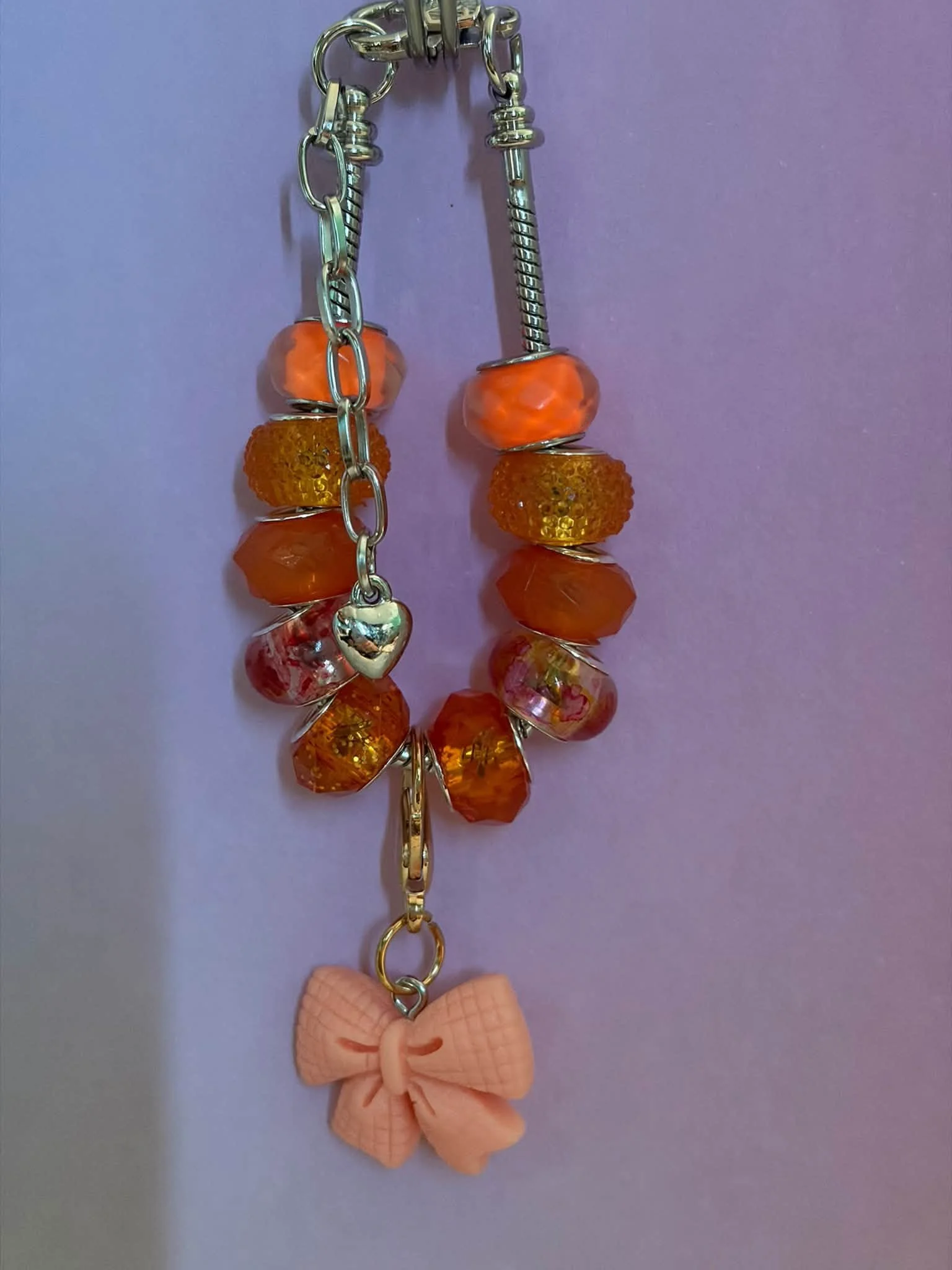Enchanting Silver Orange Bow Bracelet