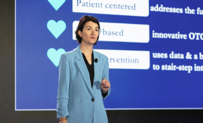 Maureen Brown speaking on stage at an industry conference during her time as CEO of Mosie Baby