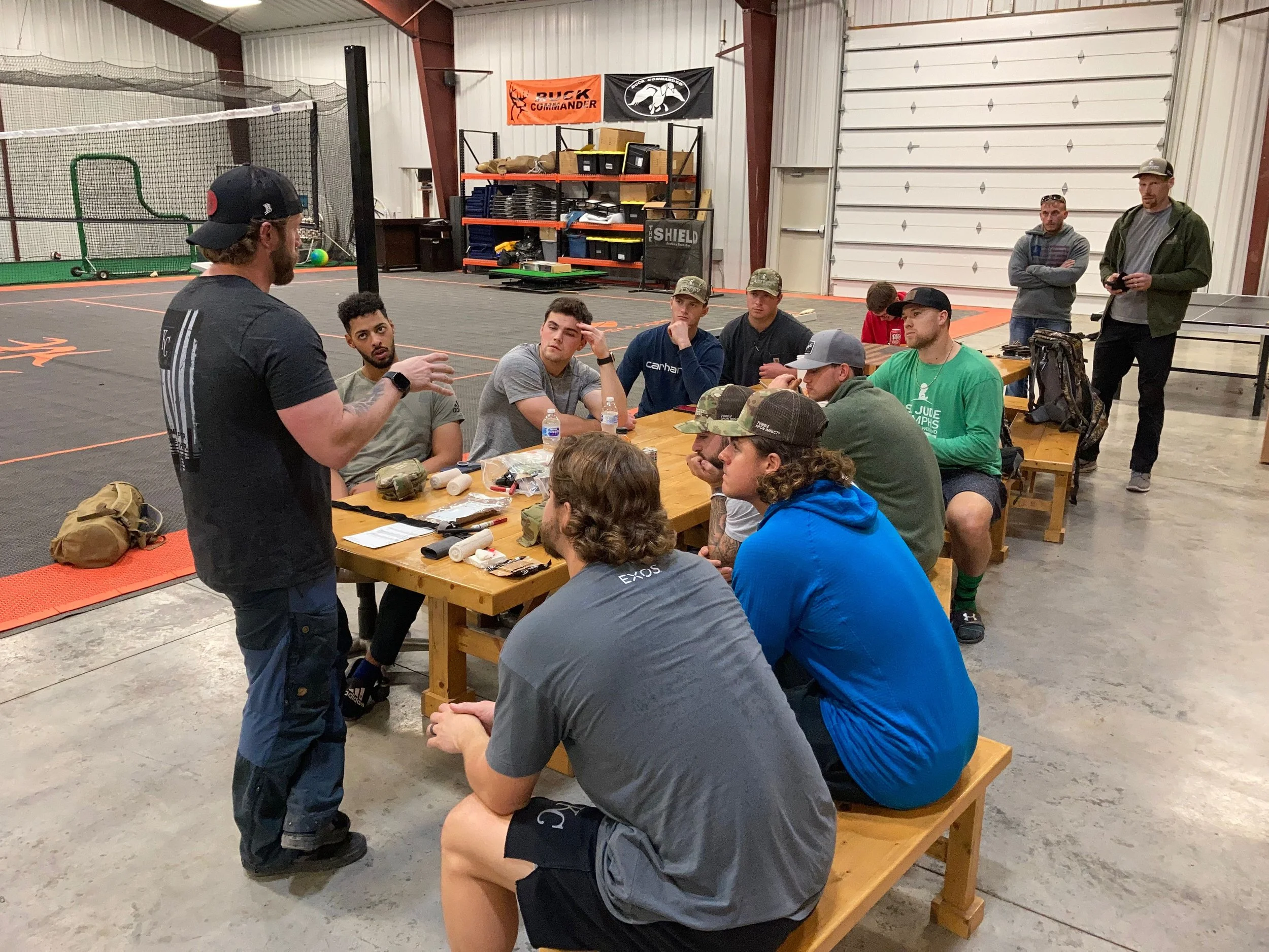 Athletes participate in a hands-on medical class, learning emergency care skills and casualty response techniques in preparation for an experiential rescue mission training event.