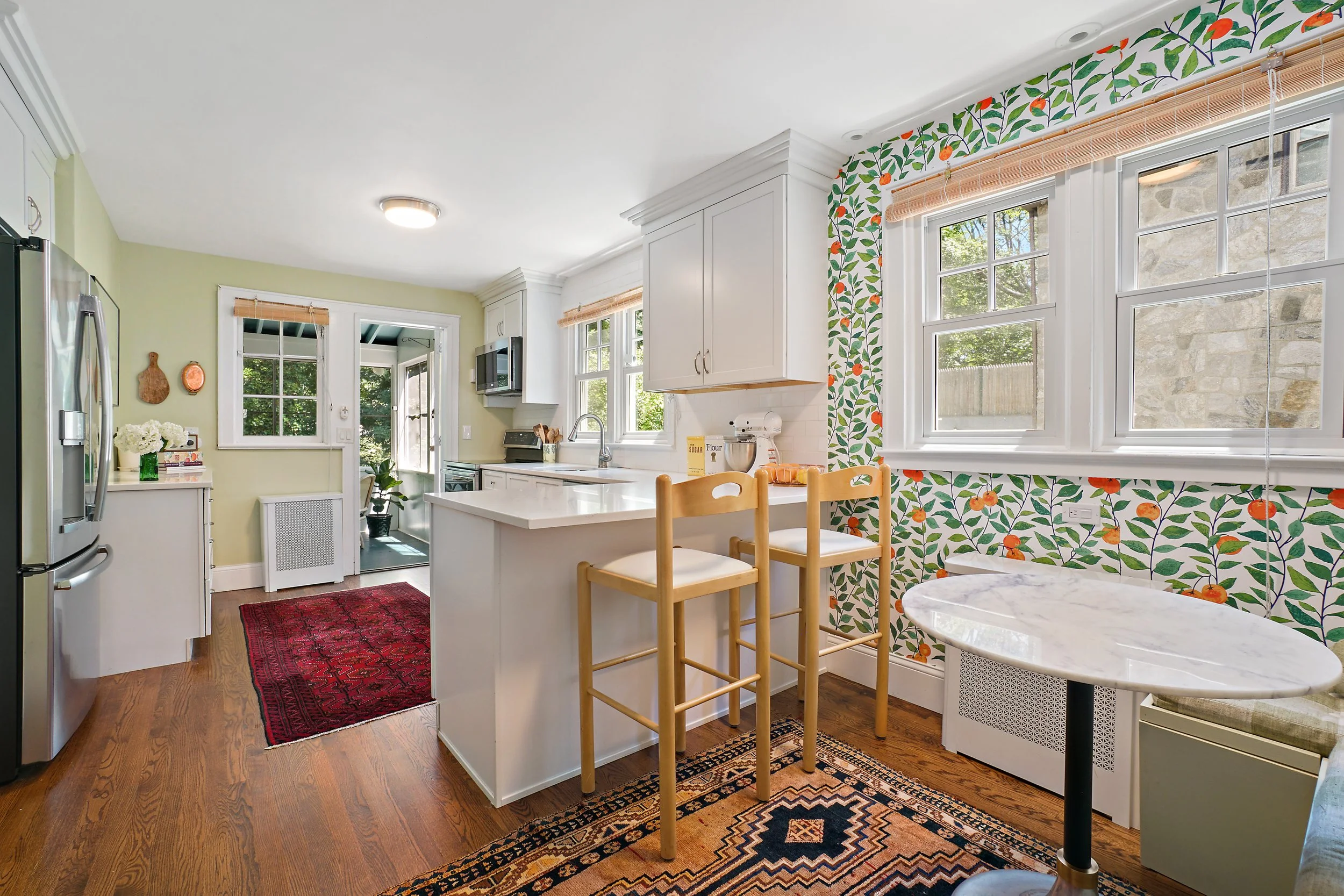Orange Crush Wallshoppe wallpaper, Marble cafe table, custom banquette, vintage persian rugs