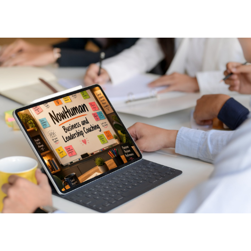 Tablet with a presentation slide on 'Northuman Business and Leadership Coaching' displayed, surrounded by people at a meeting table with notebooks and a coffee mug.