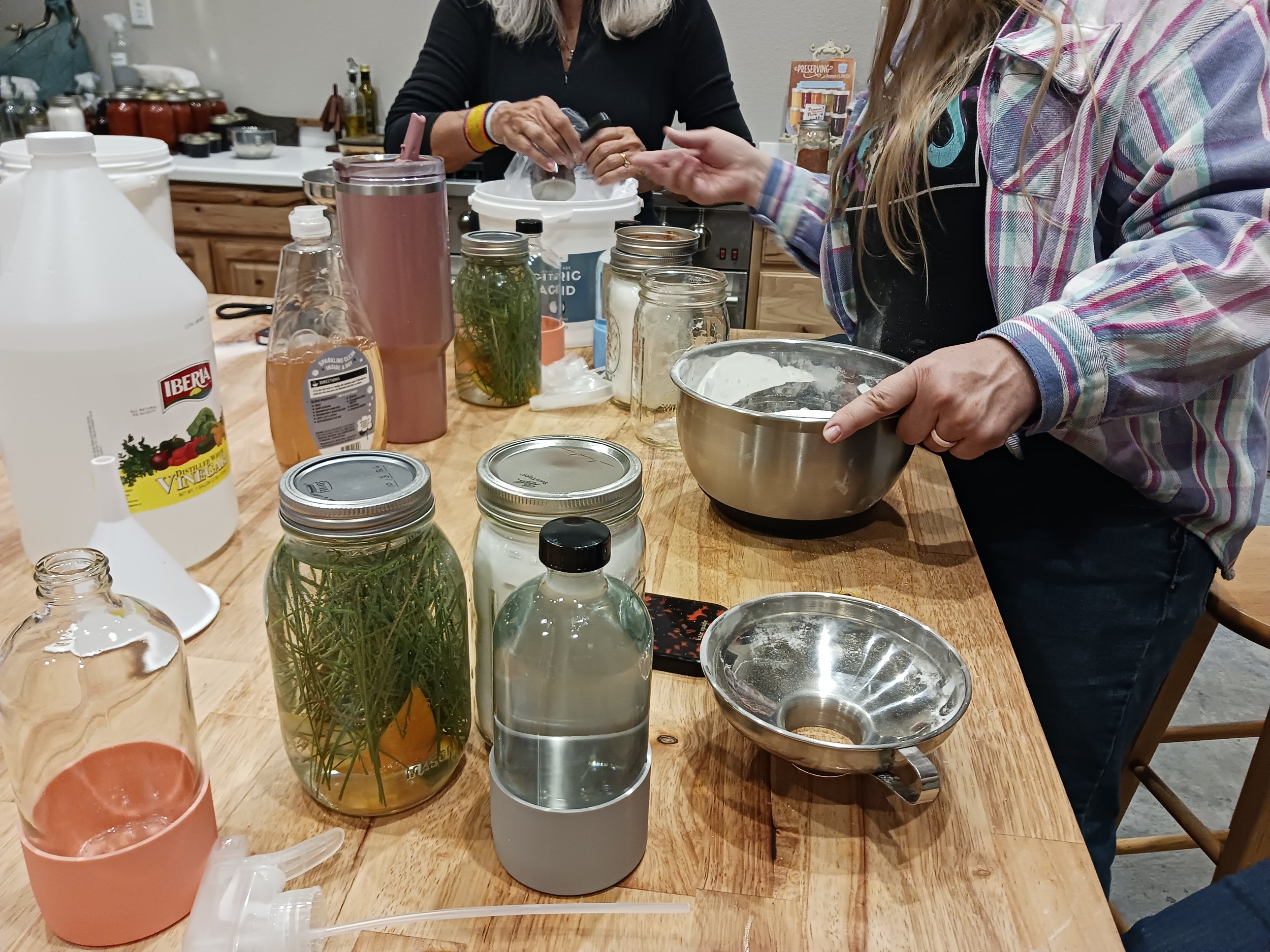 Women making natural cleaning products together.