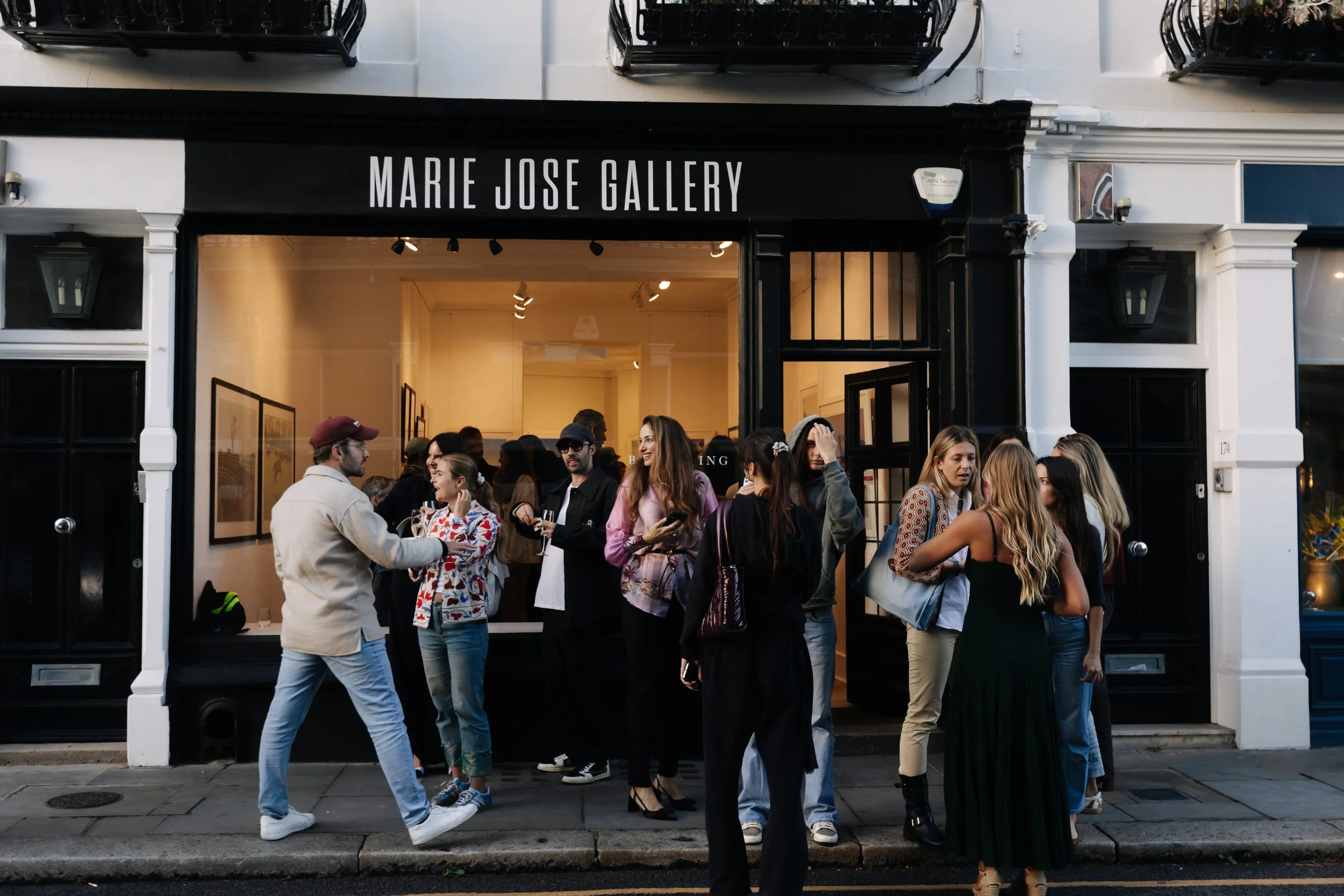 People gathered outside the Marie Jose Gallery, engaging in conversations and waiting to enter for the opening of Belonging, Sabaya Verger first exhibition