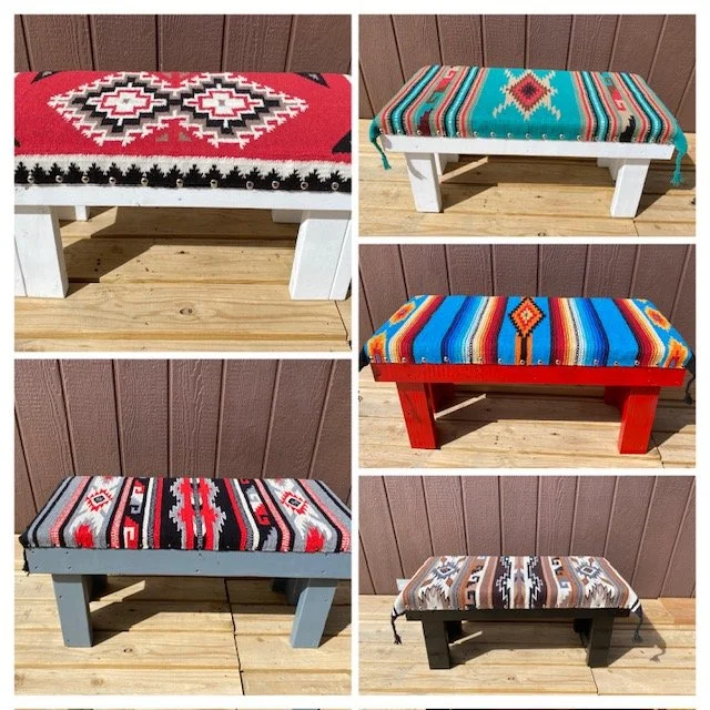 Five benches with colorful, patterned fabric cushions. They feature different southwestern or tribal designs in various colors, set against a wooden deck and brown wooden wall background.