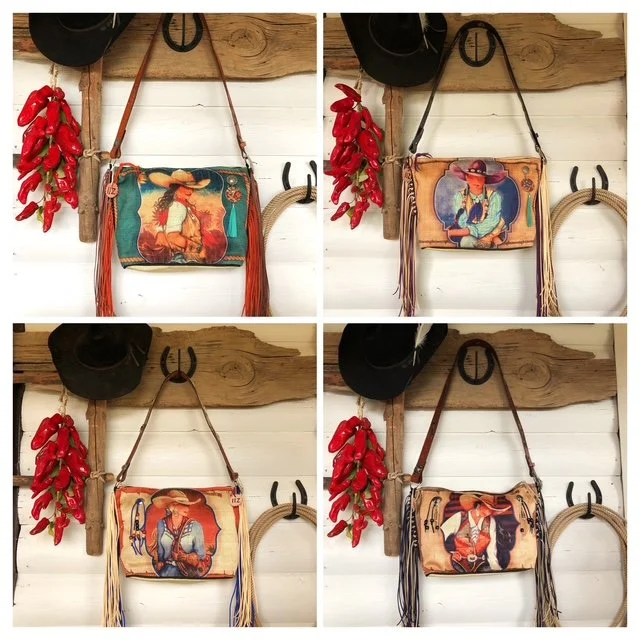 Four different vintage-style handbags with Western art designs hanging on a wooden wall, each paired with a black hat and red chili peppers on the left side.