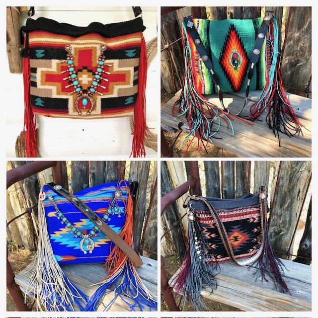 Four handbags with southwestern patterns and fringe details, displayed outdoors against a wooden background.