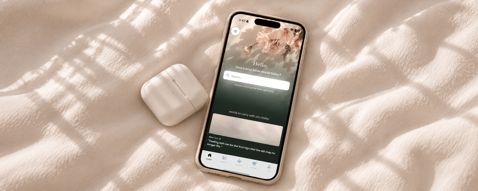 resiliently app home page displayed on iphone, sitting on white bedsheets with airpods. free daily affirmation on screen for women healing, finding her identity